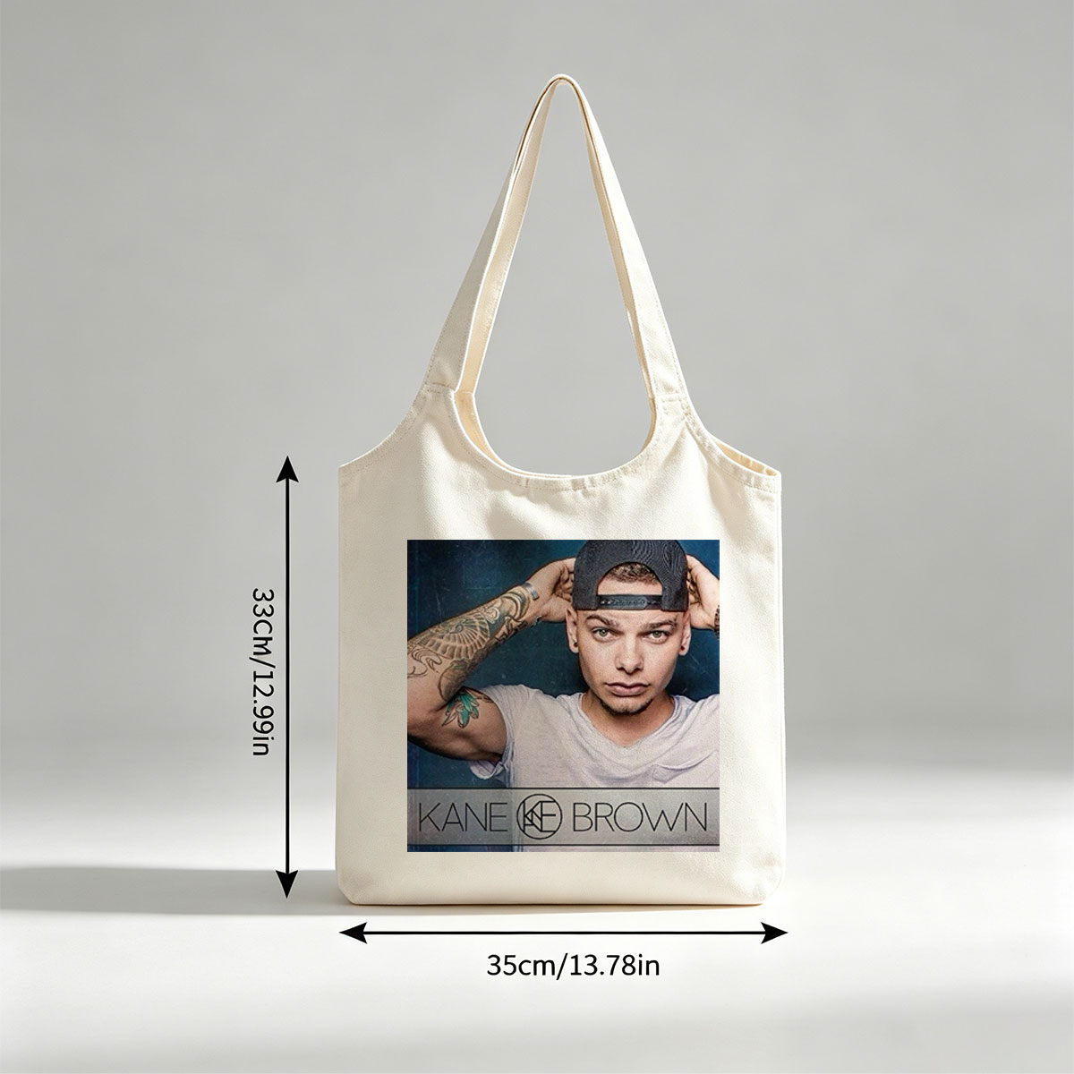 Kane Brown in a Casual Pose with Tattooed Arm and Cap on Dark Background - Canvas shoulder bags/