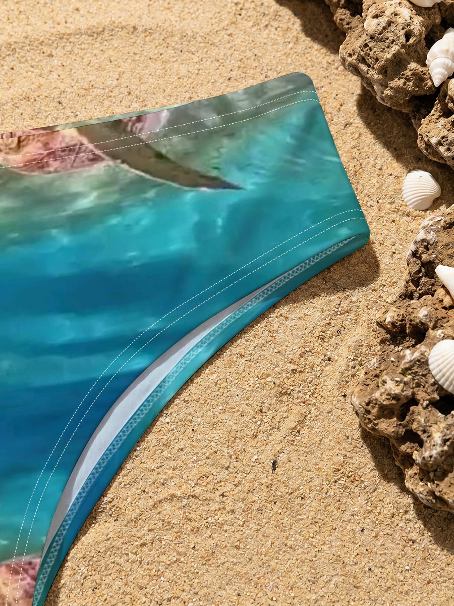 Sea turtles swim gracefully in clear blue waters, one near the surface and one gliding over sandy ocean floor. -  Men's swim trunks