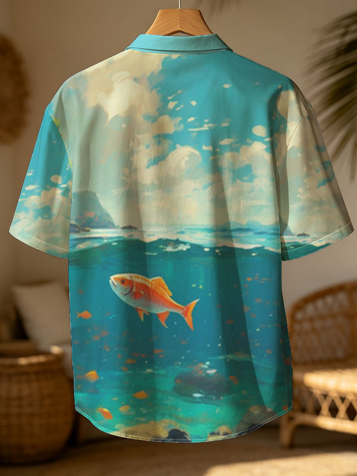A vibrant orange fish swims gracefully in clear blue waters beneath a sunny sky. -  Shirt