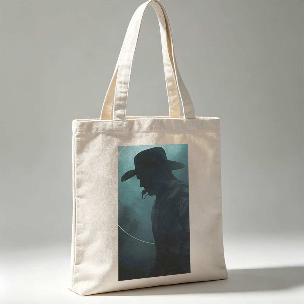 Johnny Cash in the Mist – Silhouette of a Cowboy with Hat and Pipe Against a Foggy Background - Canvas tote bags