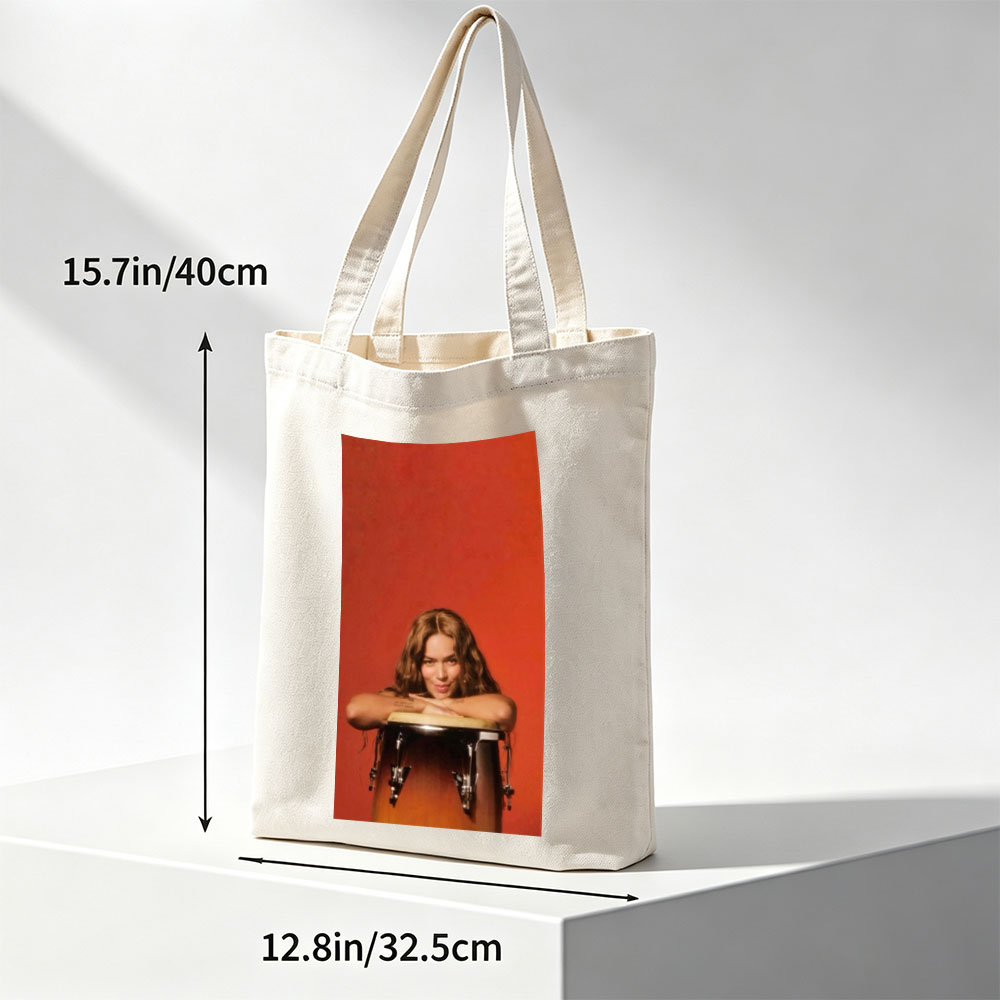 Rita Ora Leaning on a Drum Against a Red Background - Canvas tote bags