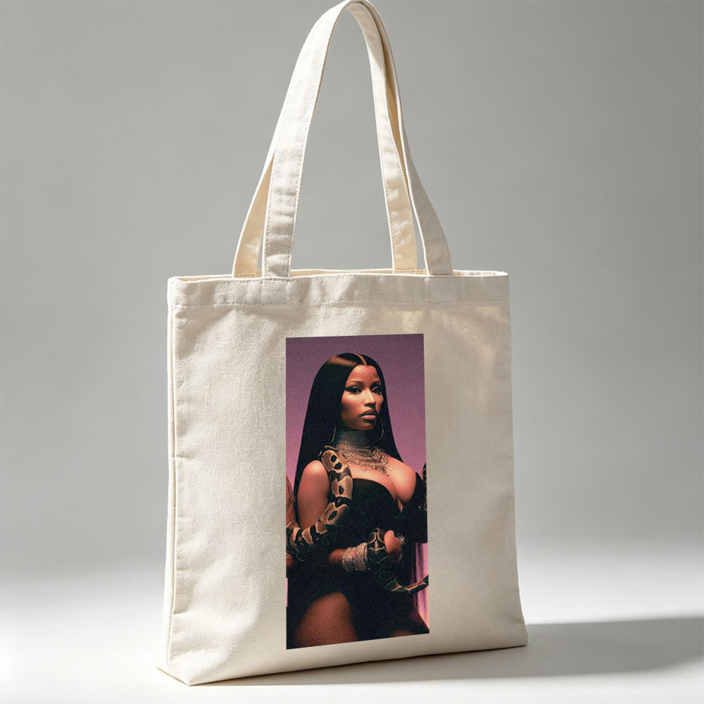 Nicki Minaj in a Dramatic Pose with a Snake Wrapped Around Her Arm and Neck, Wearing a Black Outfit and Heavy Jewelry - Canvas tote bags