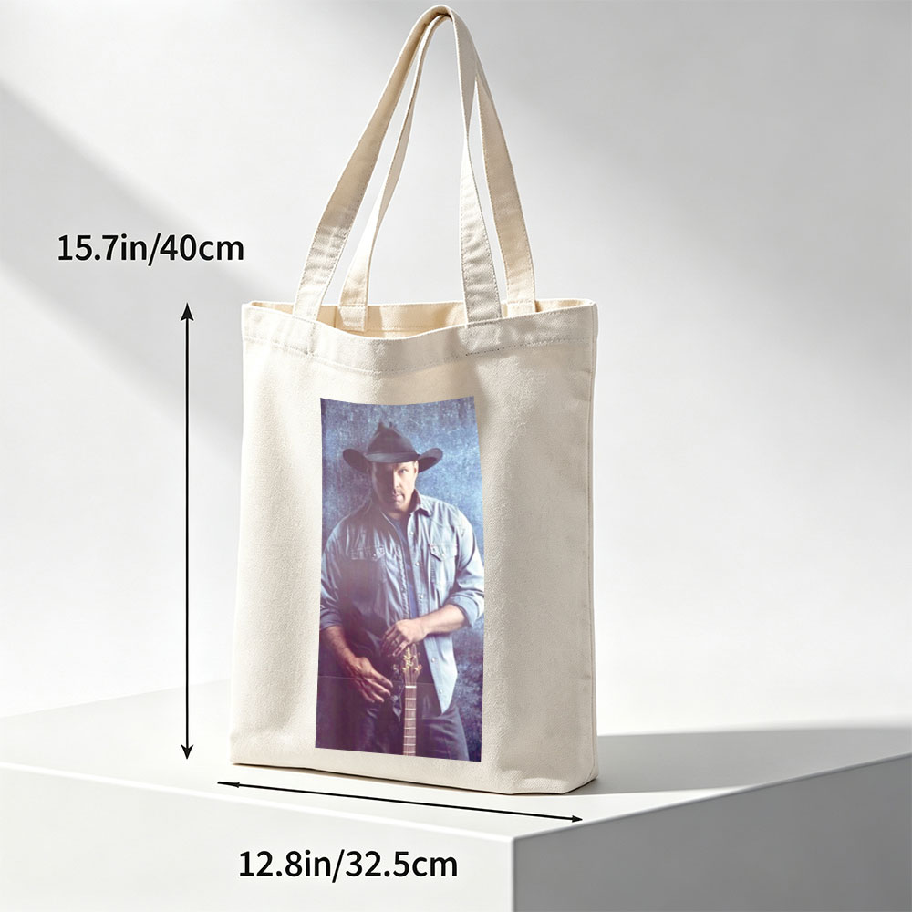 Garth Brook in Cowboy Hat Holding Guitar Against Textured Background - Canvas tote bags