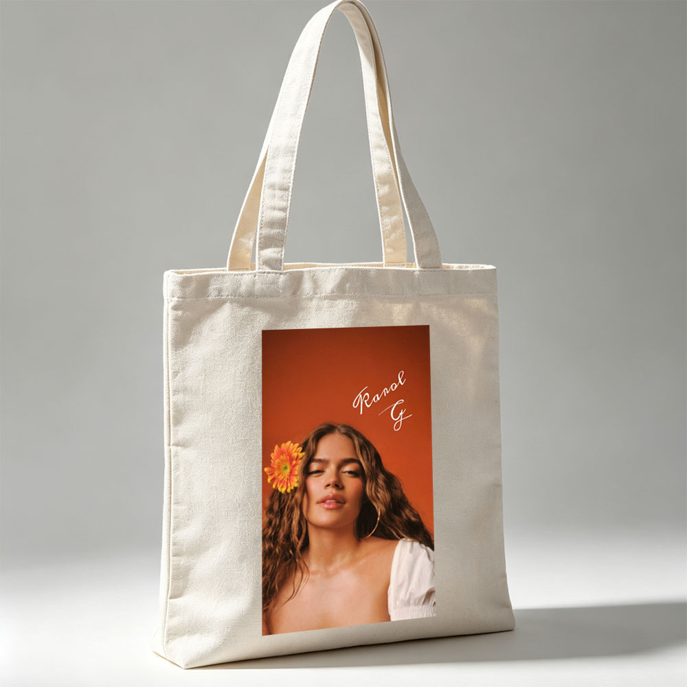 Ranal G with a vibrant orange flower in her hair against a warm terracotta background - Canvas tote bags