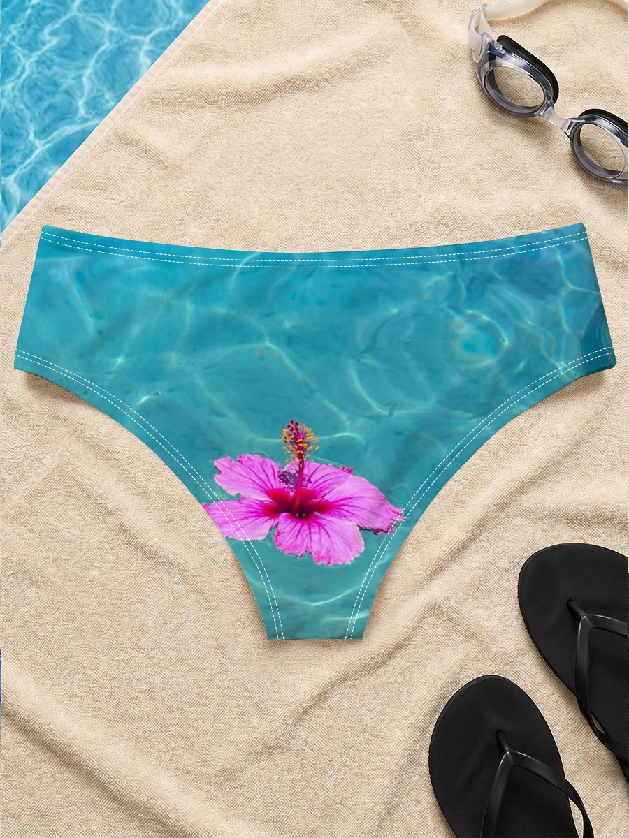 Pink hibiscus floating on crystal clear turquoise water -  Men's swim trunks