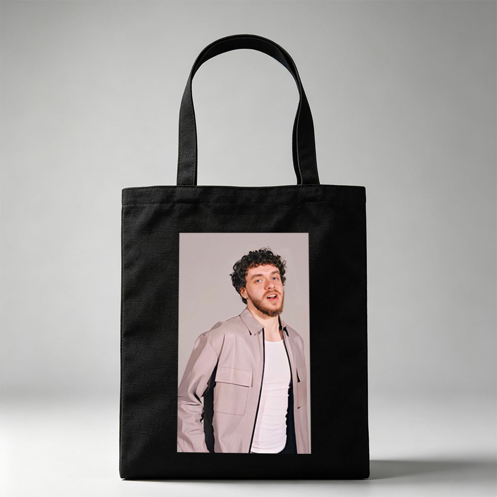 Jack Harlow in a Stylish Pose Wearing a Beige Jacket Over a White Shirt Against a Neutral Background - Canvas tote bags