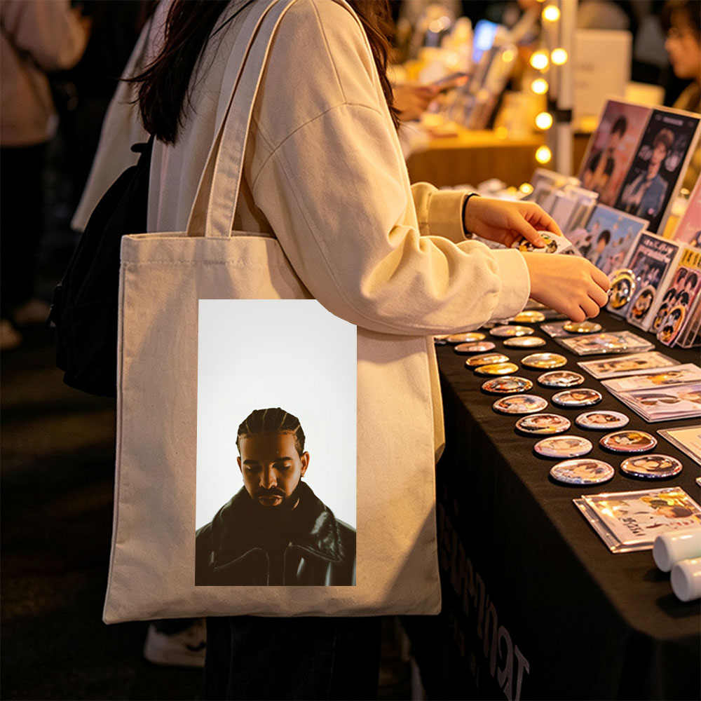 Drake in a Moody Portrait Wearing a Black Leather Jacket with Braided Hair and a Contemplative Expression - Canvas tote bags