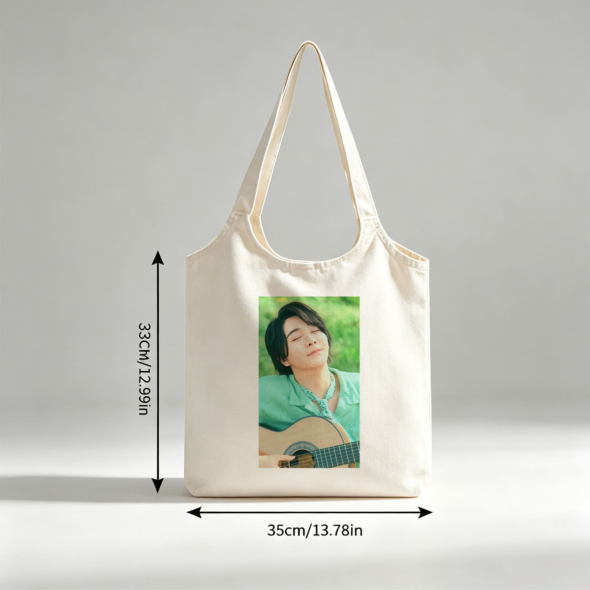 Yuki Kajiura in a Serene Outdoor Setting Playing Acoustic Guitar with Eyes Closed - Canvas shoulder bags/