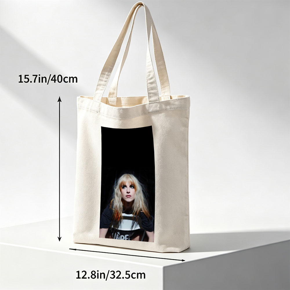Hayley Williams in a Dramatic Portrait with Intense Gaze and Blonde Hair Against Dark Background - Canvas tote bags