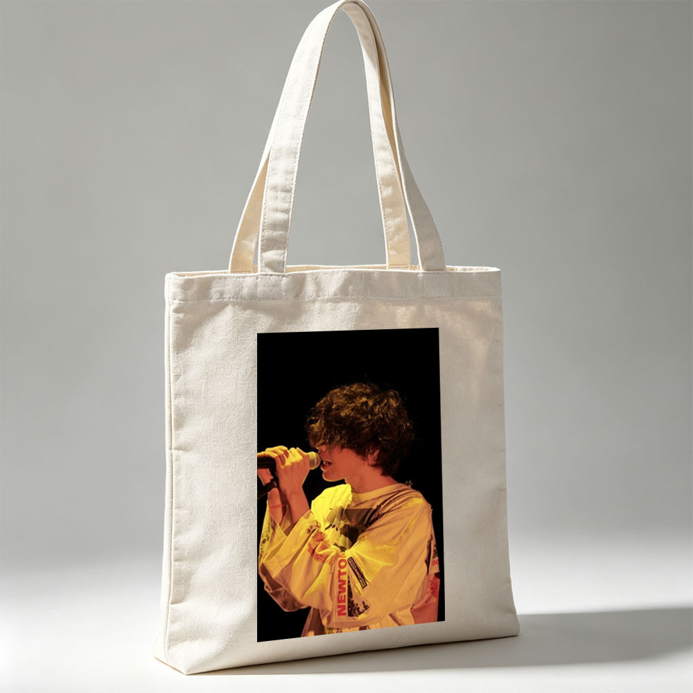 Harry Styles Singing on Stage in a Yellow Outfit with Microphone - Canvas tote bags