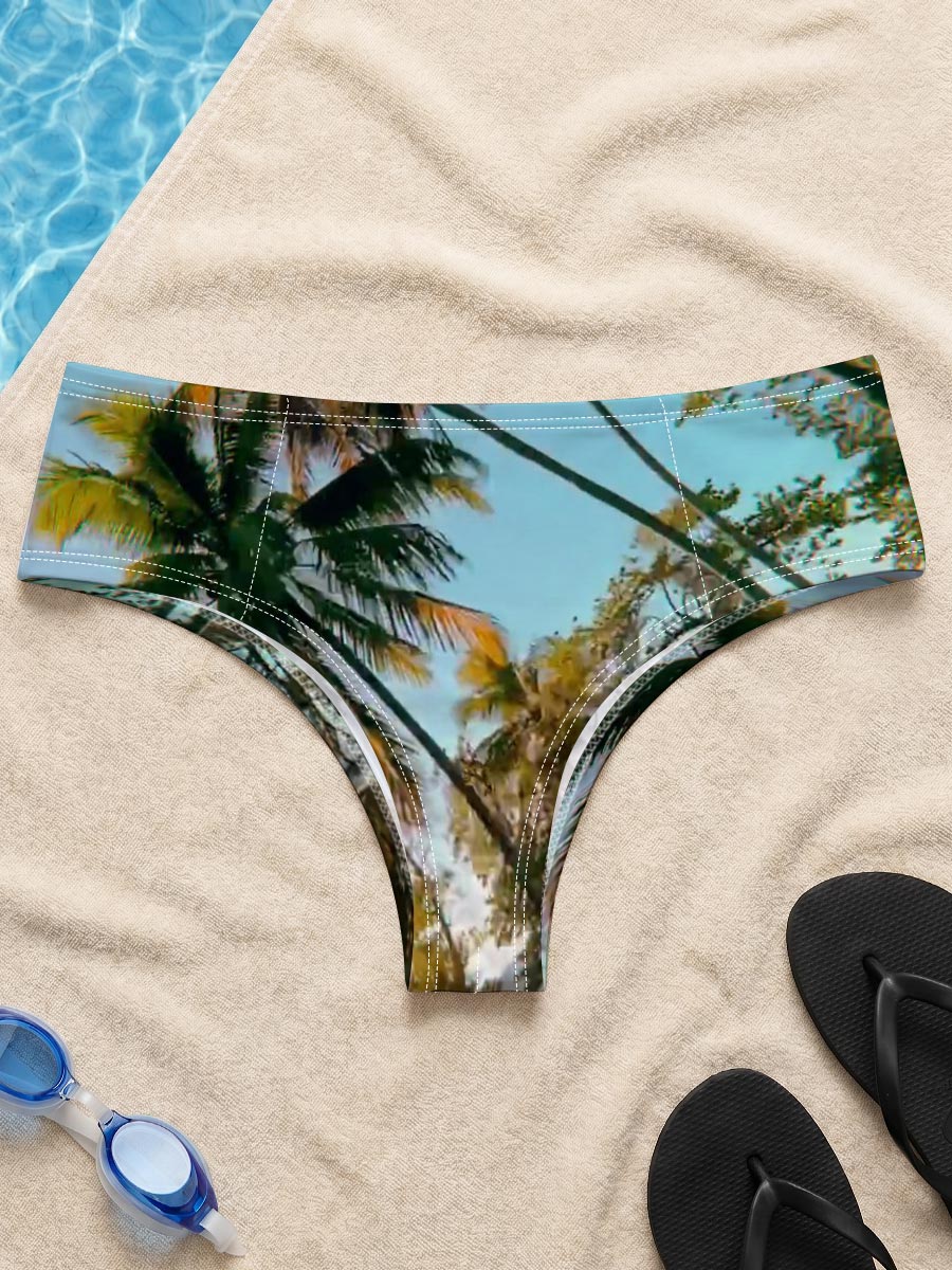 Tropical palm trees sway under a clear blue sky, casting golden shadows on the ground. -  Men's swim trunks