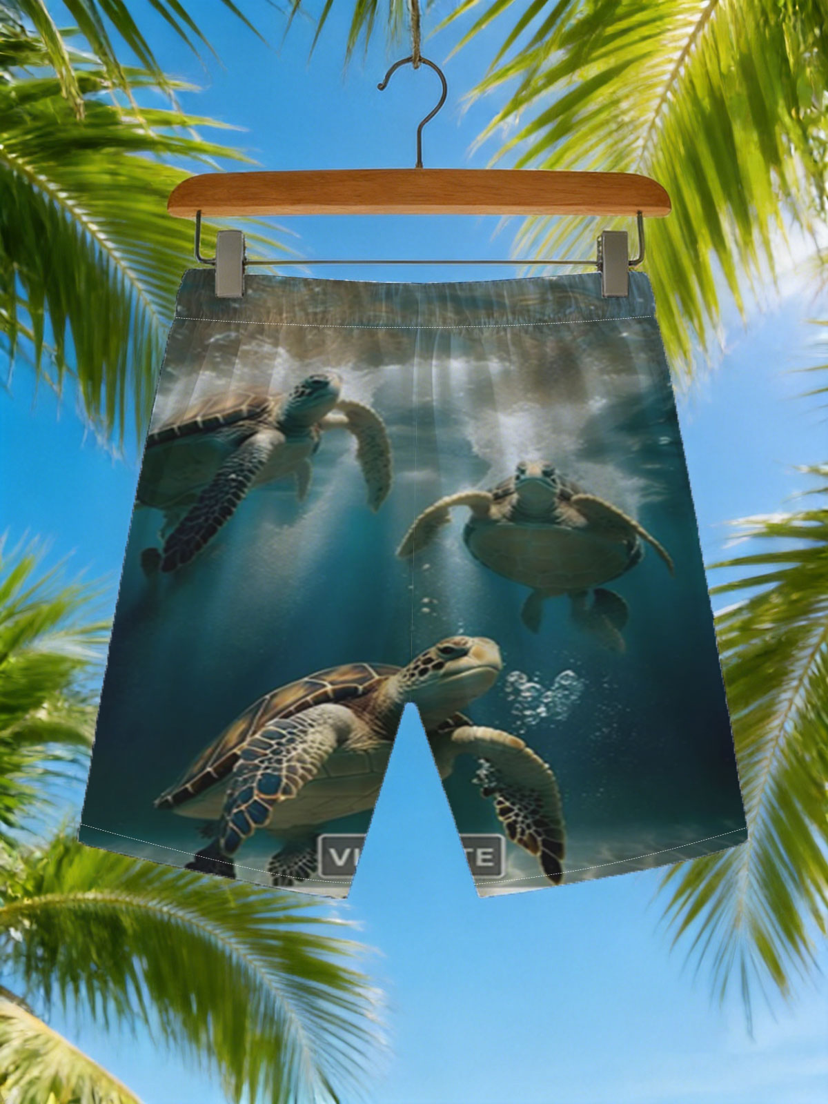 Three sea turtles swimming gracefully underwater in clear blue ocean. -  Beach shorts