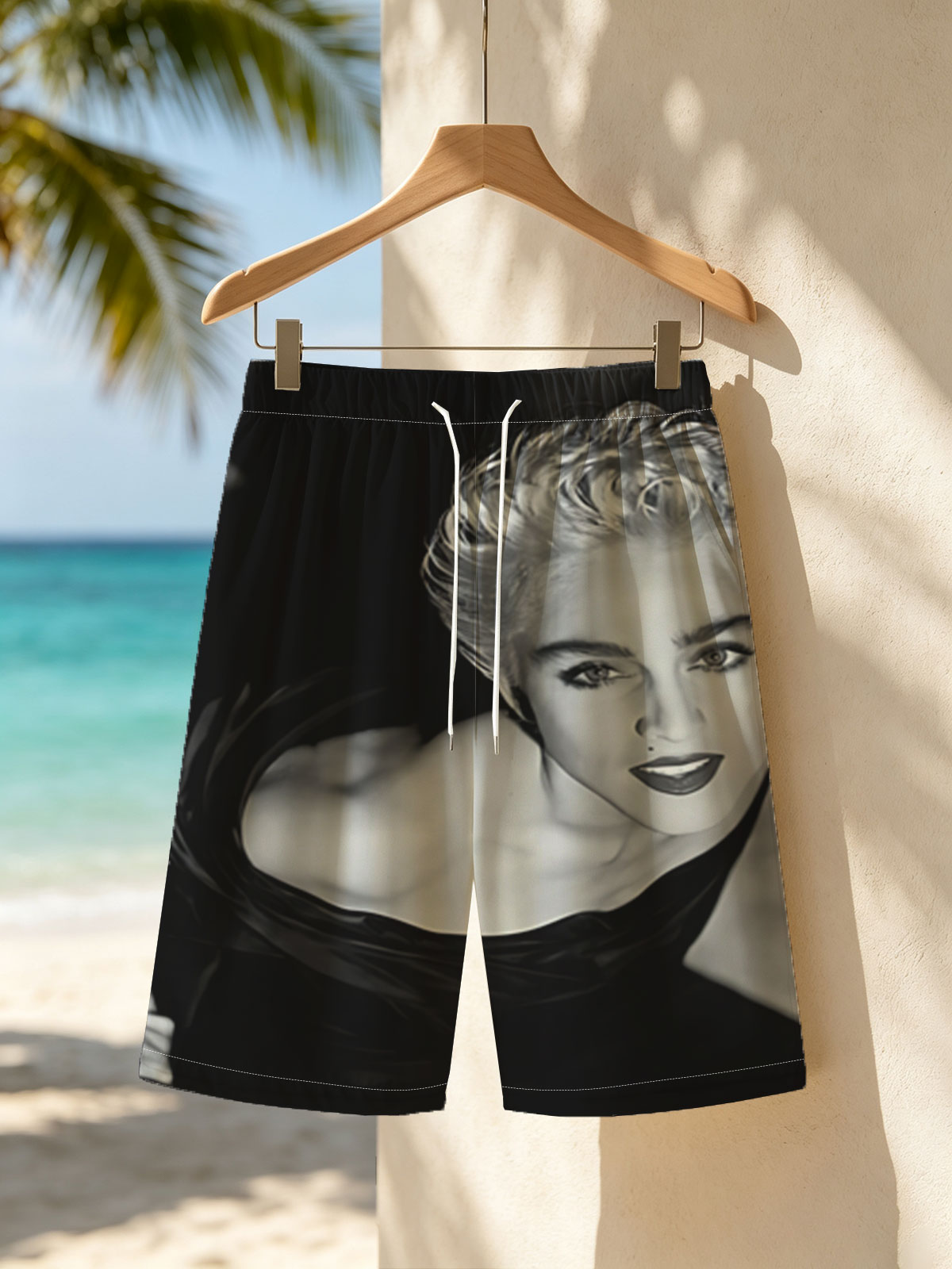 Madonna in a striking black and white portrait, showcasing bold makeup and voluminous blonde hair. -  Beach shorts