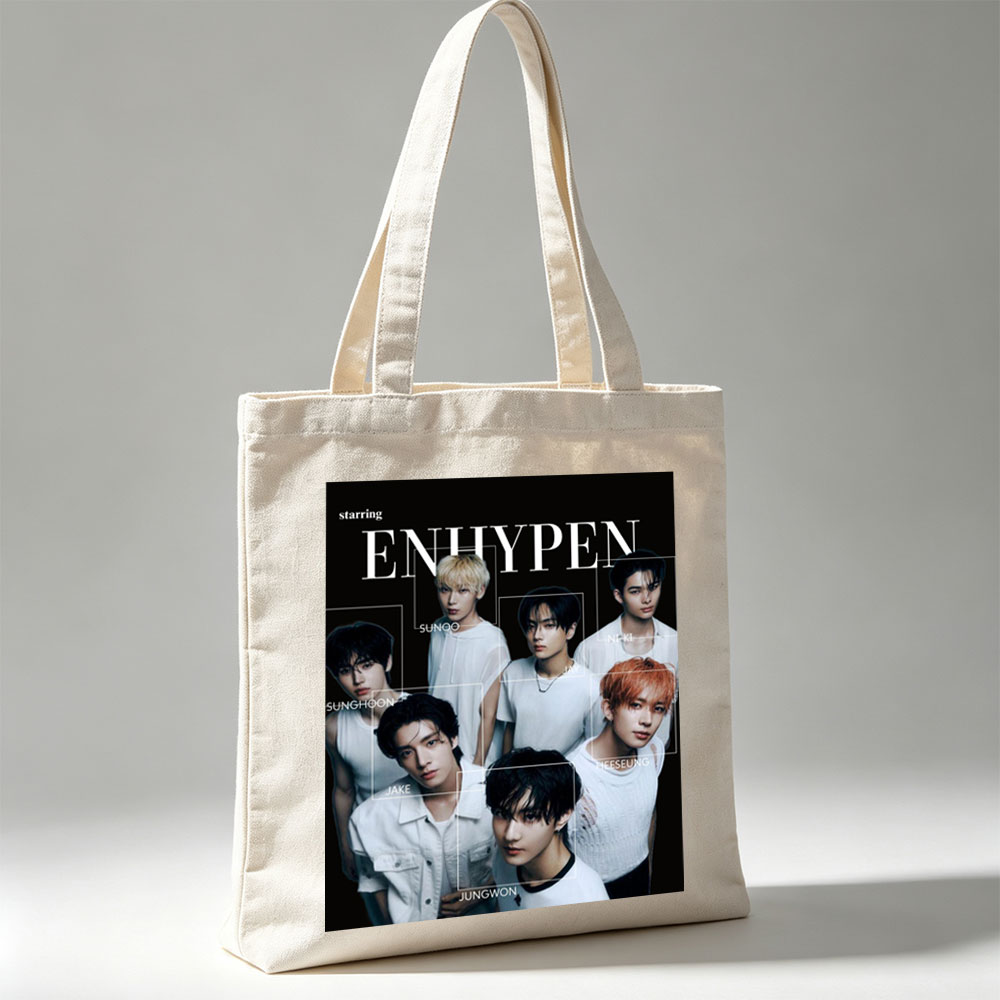 ENHYPEN in a striking black-and-white group portrait featuring all members in minimalist white outfits with individual name labels against a dark background - Canvas tote bags