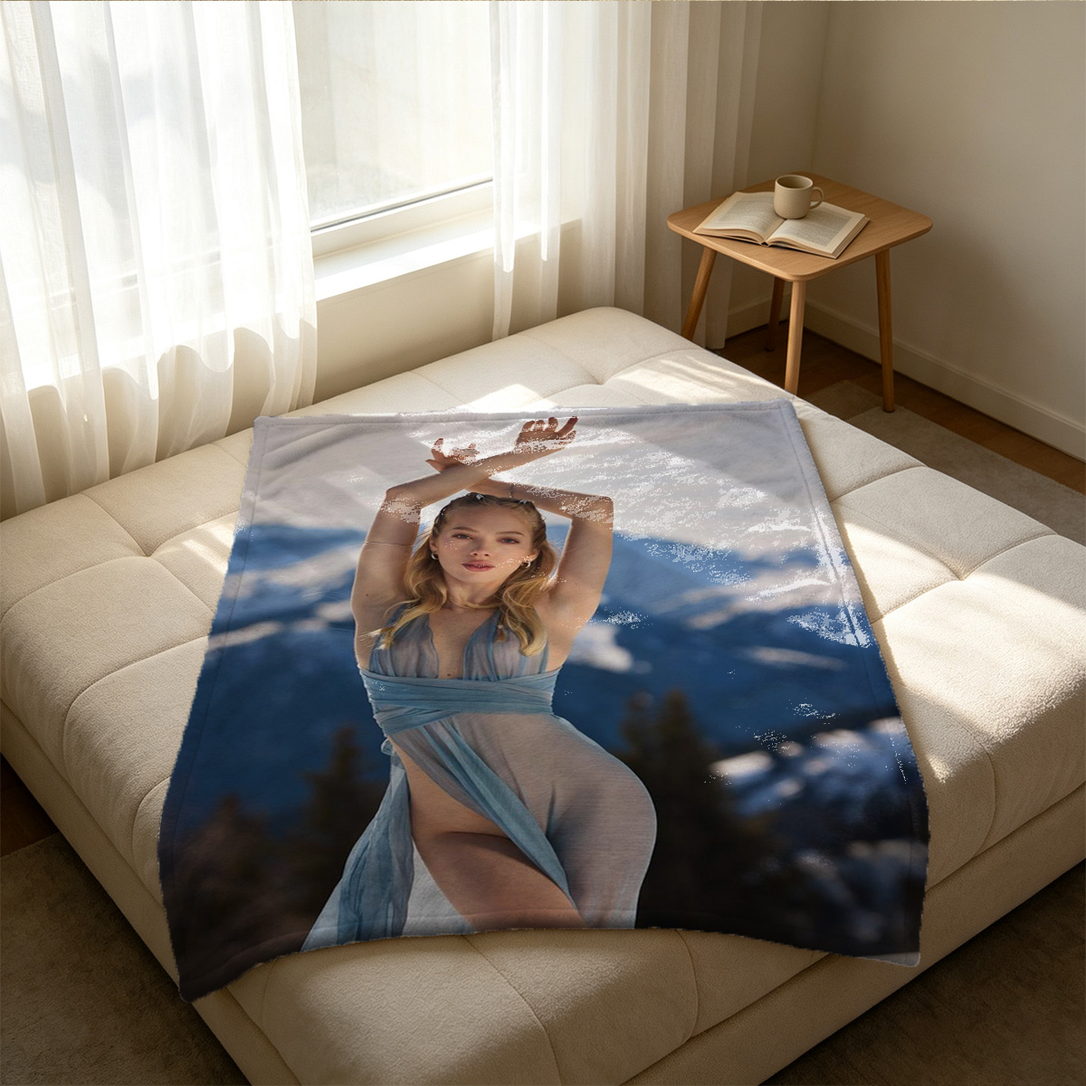 A woman in a sheer blue lingerie set posing seductively on a bed. - Blanket