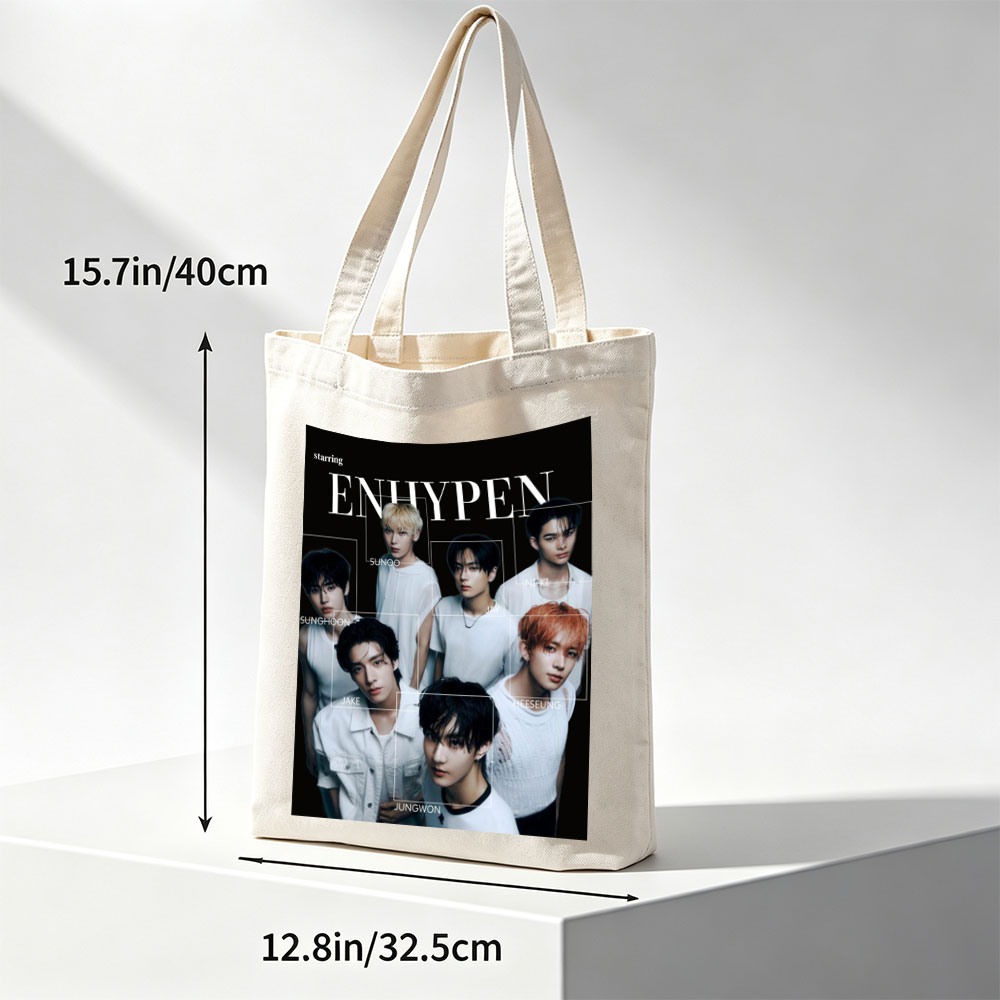 ENHYPEN in a striking black-and-white group portrait featuring all members in minimalist white outfits with individual name labels against a dark background - Canvas tote bags