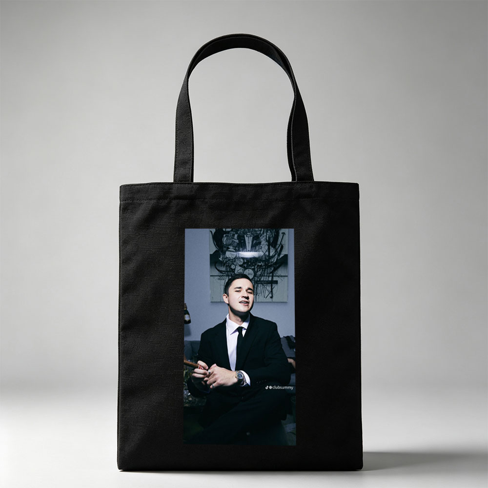 Pete Davidson in a Suit Holding a Cigar with Artwork in the Background - Canvas tote bags