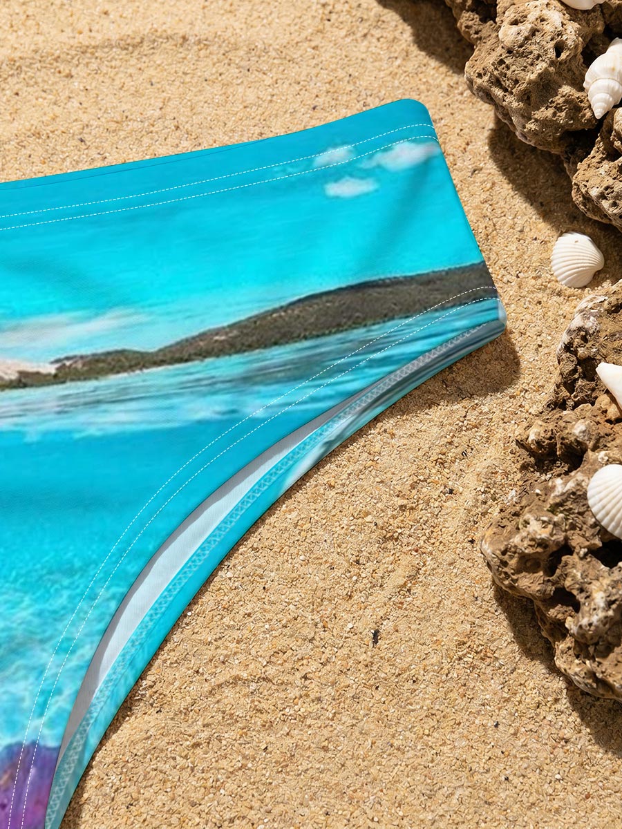 Hand holding a pink hibiscus flower over crystal-clear turquoise water under a bright blue sky. -  Men's swim trunks