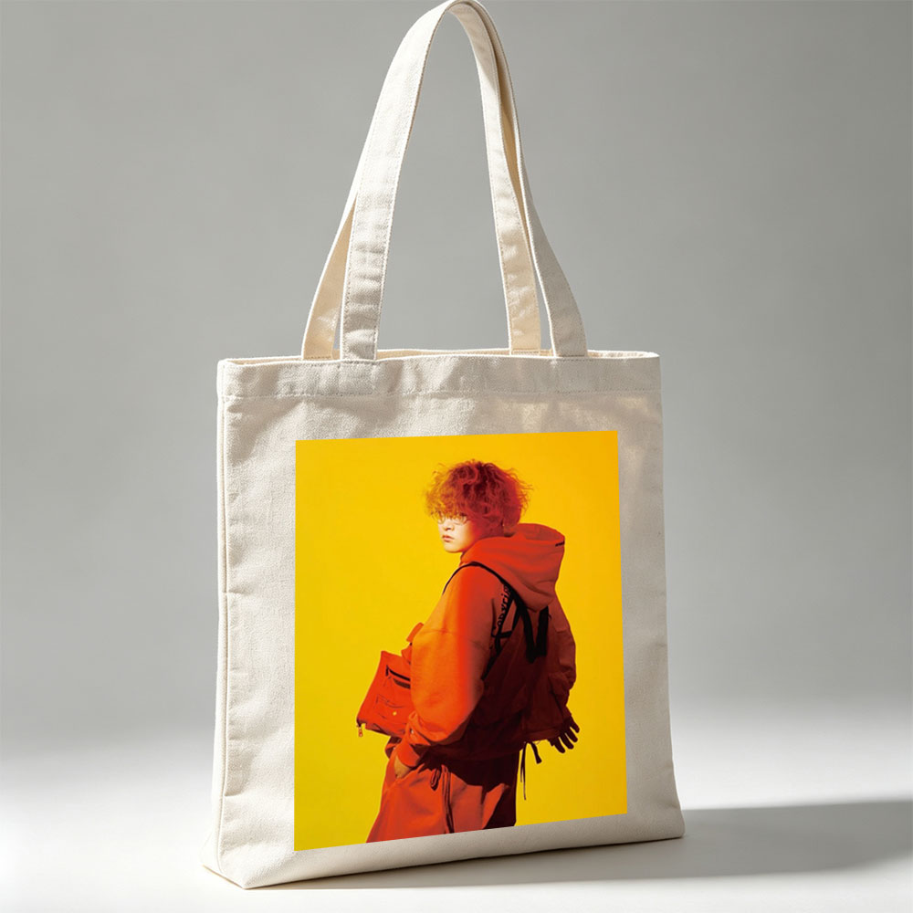 Yuta from Exile Tribe in a Bold Orange Outfit with a Backpack Against a Vibrant Yellow Background - Canvas tote bags