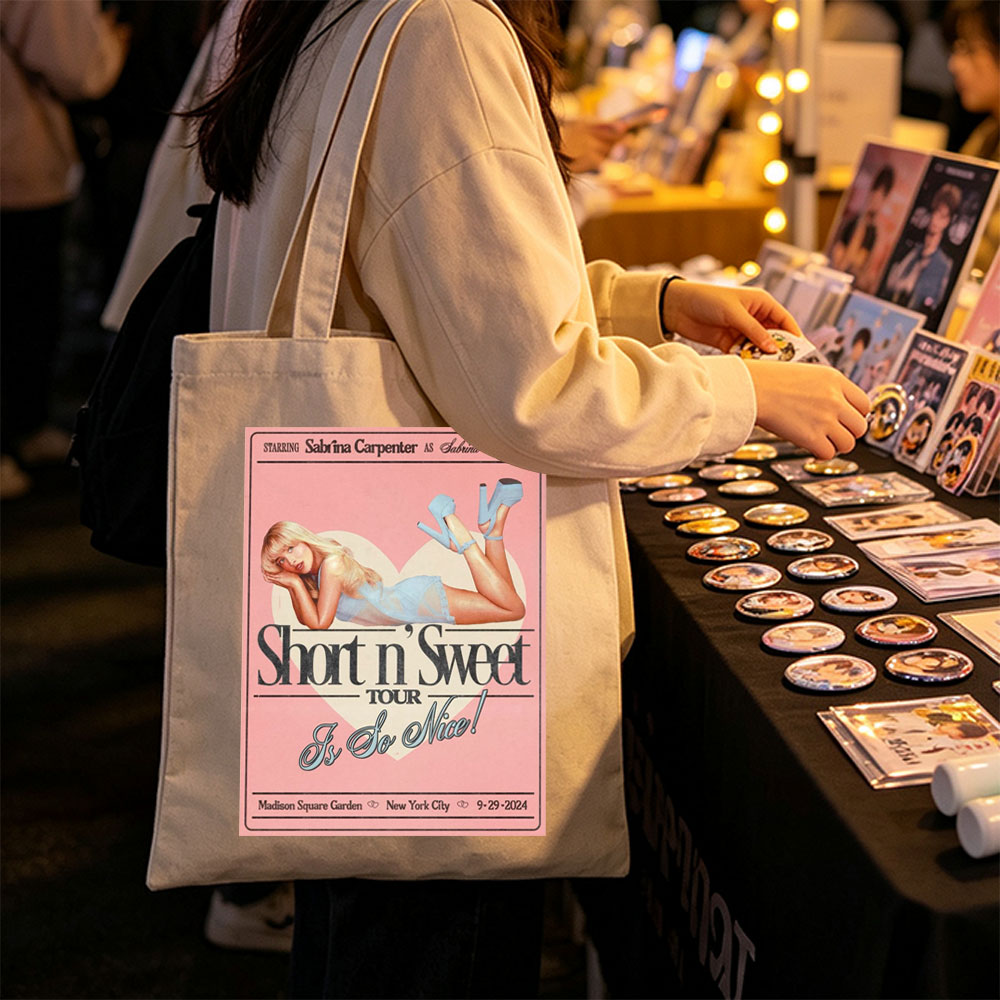 Sabrina Carpenter Short n' Sweet Tour Poster Featuring Her in a Blue Dress and Heels Lying on a Heart Background - Canvas tote bags