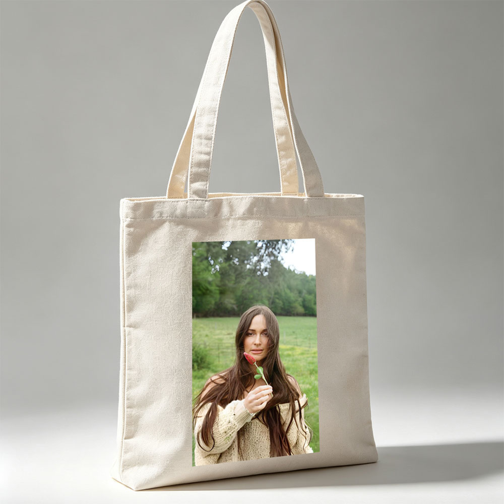 Lily-Rose Depp in a Serene Field Holding a Red Flower - Canvas tote bags