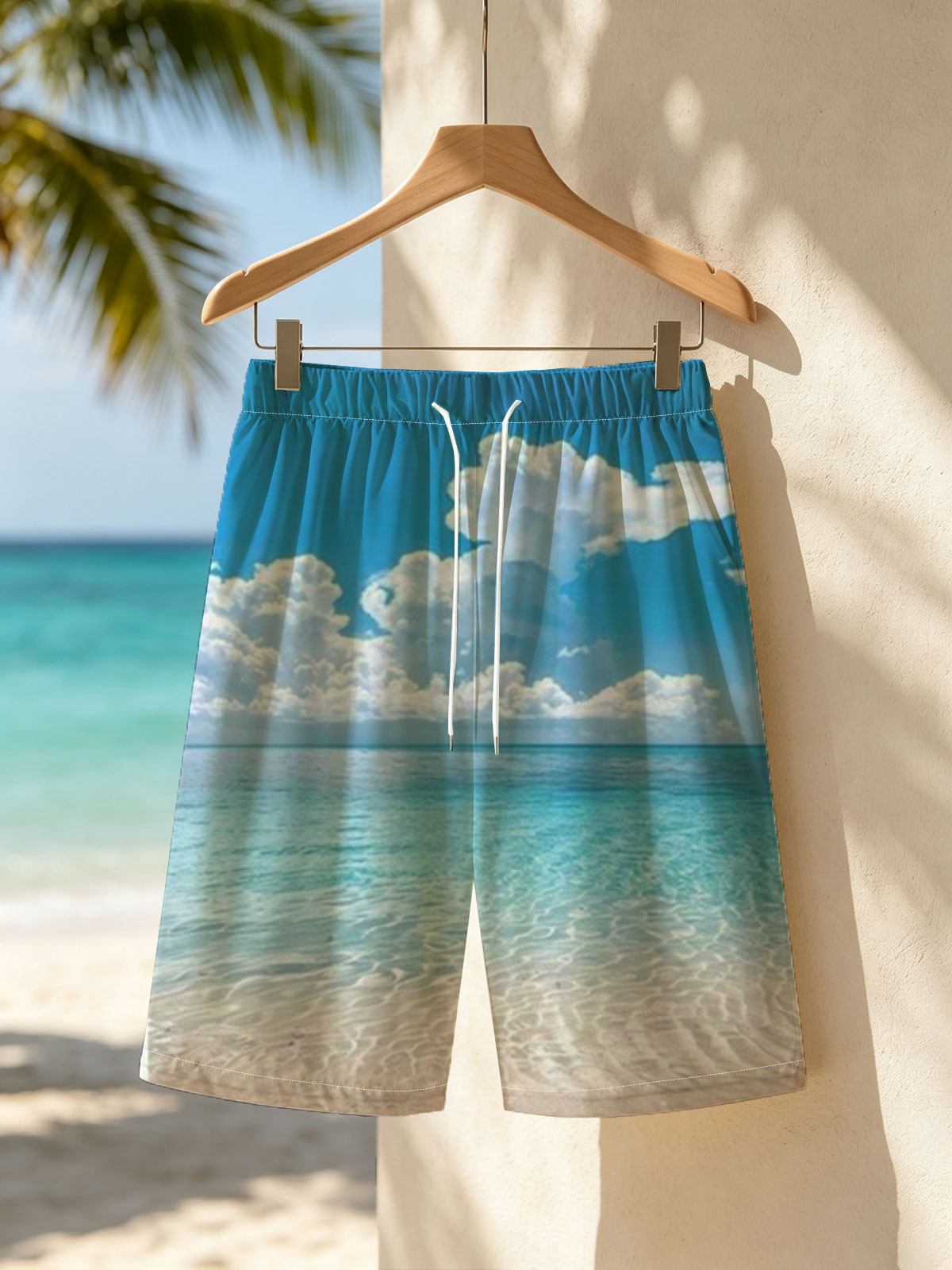 Crystal clear turquoise waters meet soft sandy beach under a vibrant blue sky with fluffy white clouds. -  Beach shorts