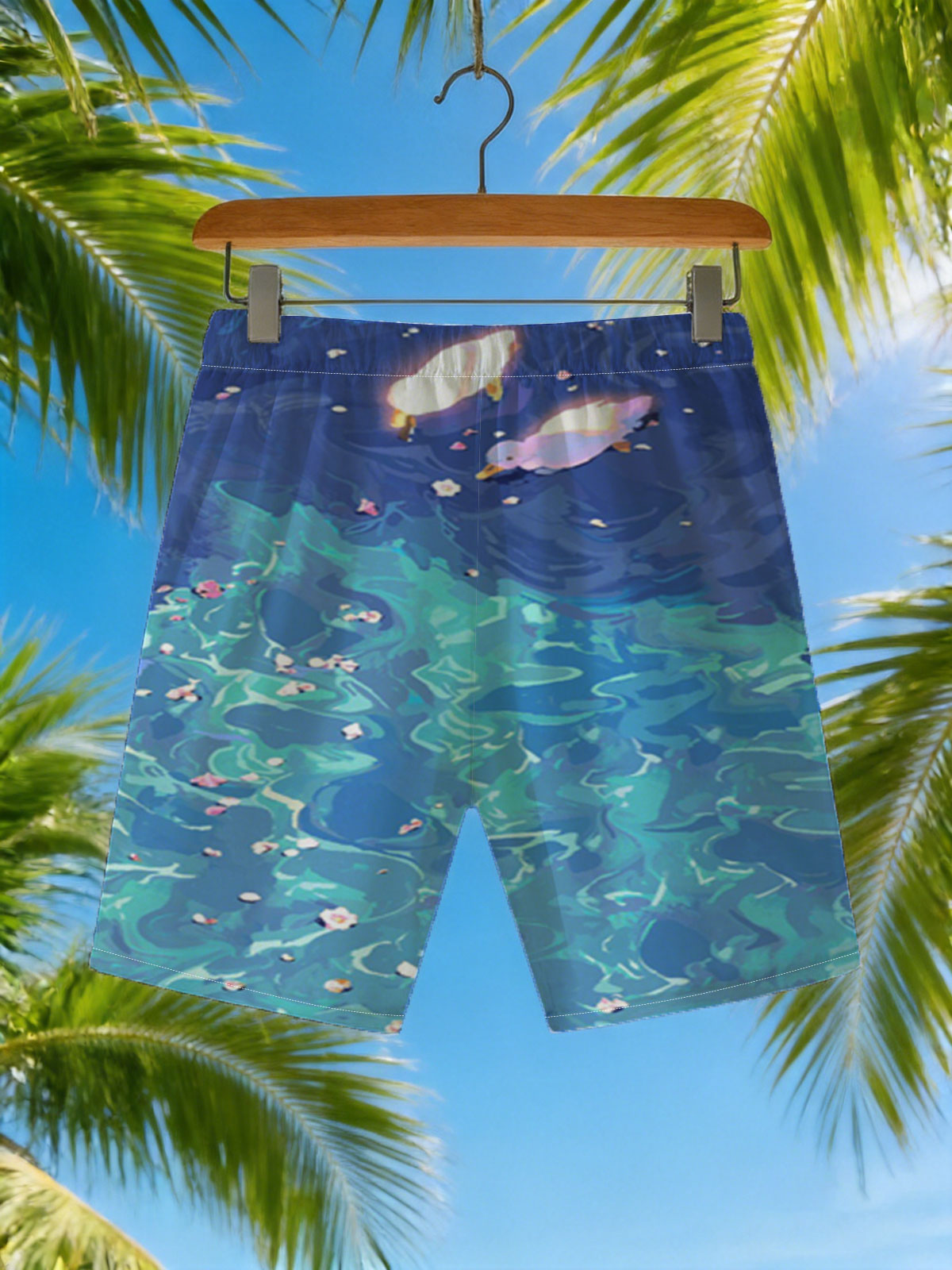 Ducks floating on a vibrant blue pond with scattered petals -  Beach shorts