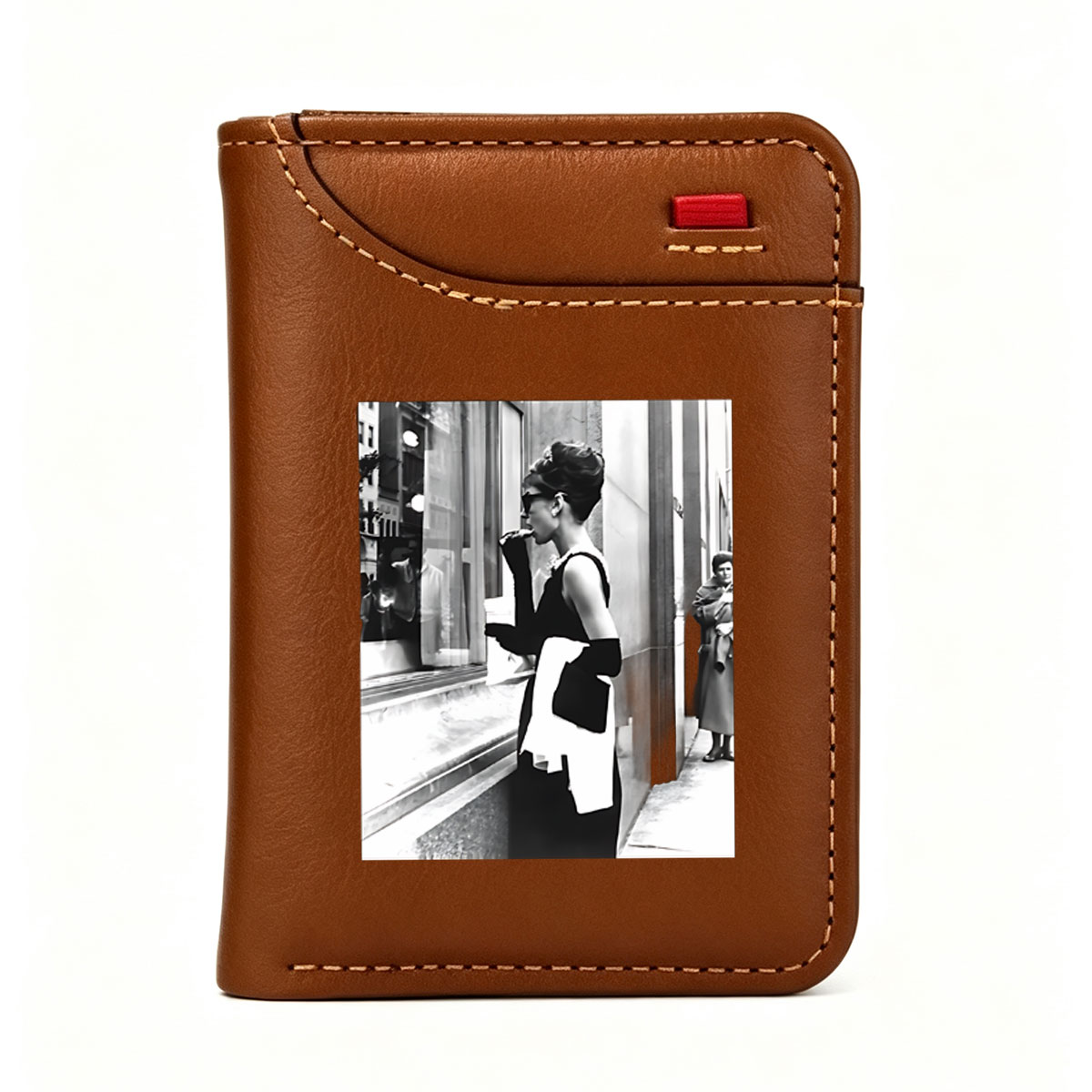 Audrey Hepburn in iconic black dress and sunglasses, standing by a window display, holding a white scarf and cigarette holder. - Vertical Style Wallet