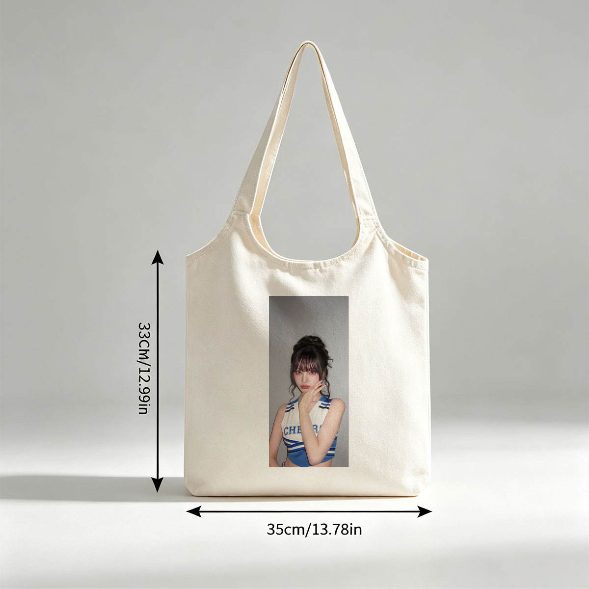 K-pop Idol in Cheerleader Outfit Poses with Hand on Face Against Gray Background - Canvas shoulder bags/