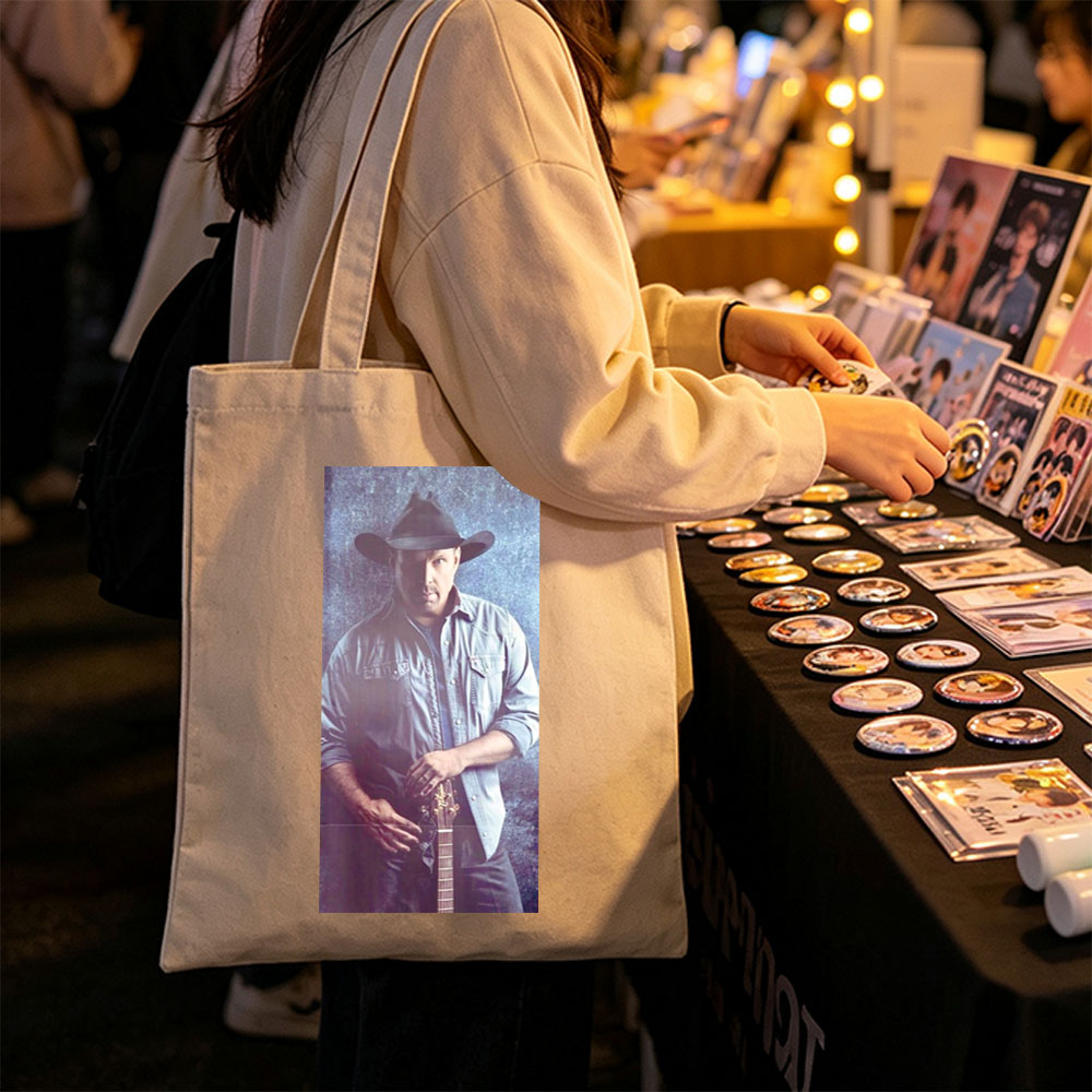 Garth Brook in Cowboy Hat Holding Guitar Against Textured Background - Canvas tote bags