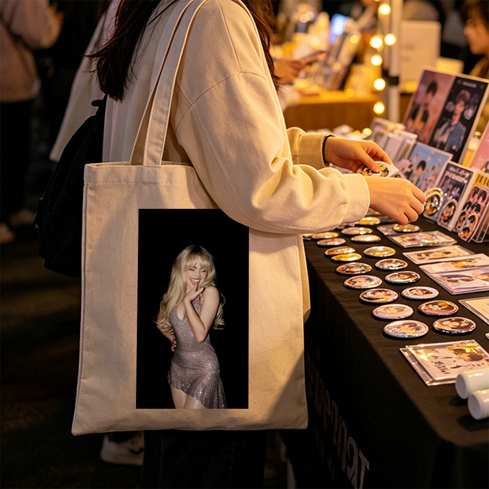 Sabrina Carpenter in a Sparkling Dress Posing with a Smile Against a Black Background - Canvas tote bags