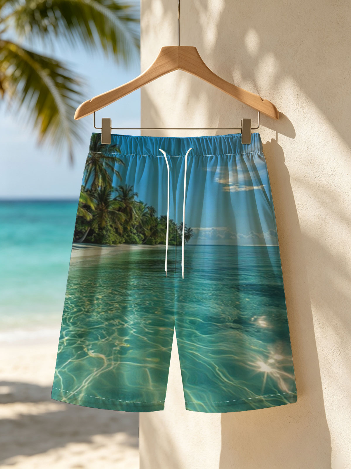 Crystal-clear turquoise waters meet a pristine white sand beach lined with lush palm trees under a bright blue sky. -  Beach shorts