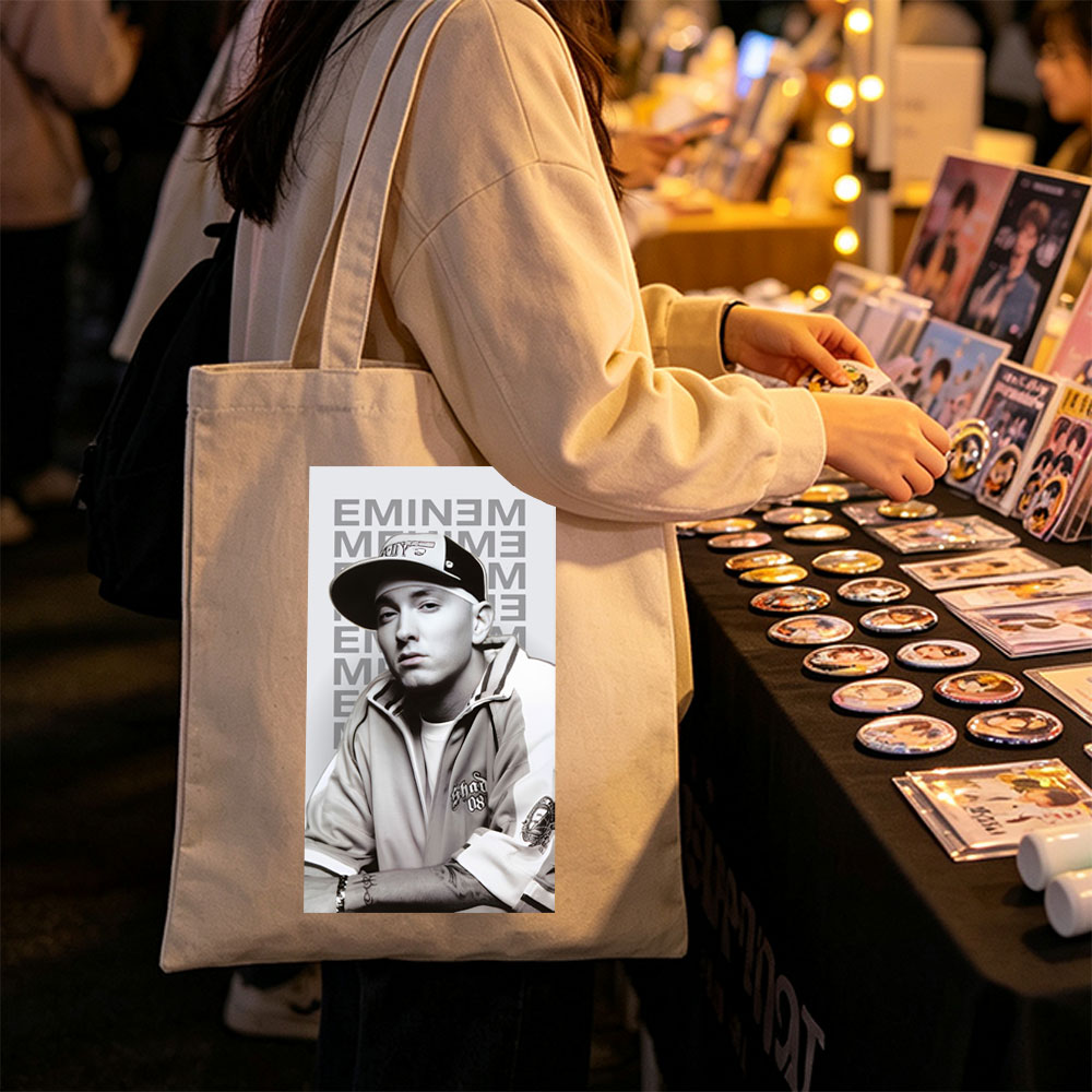 Eminem in a Casual Pose Wearing a Cap and Track Jacket with Tattooed Arms - Canvas tote bags