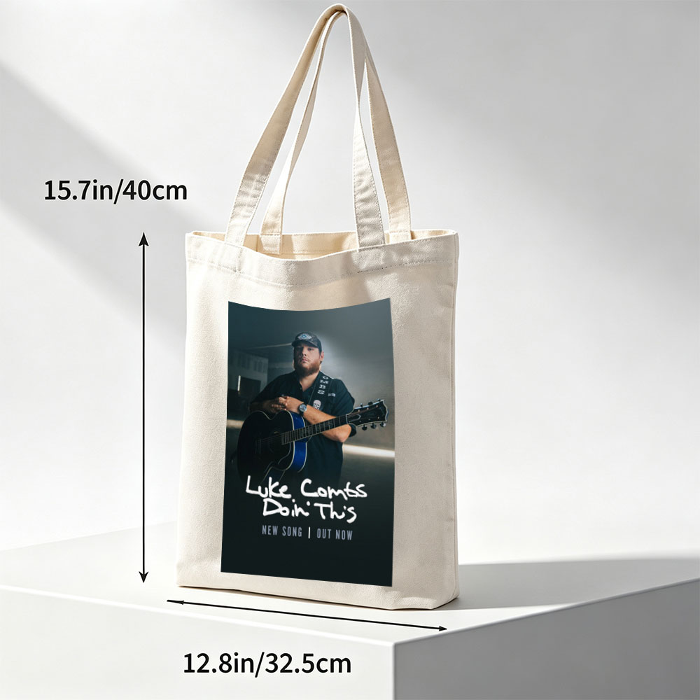 Luke Combs Holding Acoustic Guitar in Dark Studio Setting for New Song Release - Canvas tote bags
