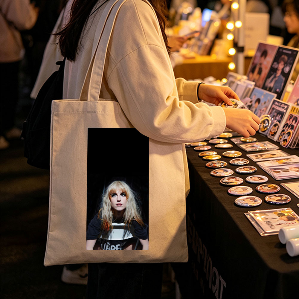 Hayley Williams in a Dramatic Portrait with Intense Gaze and Blonde Hair Against Dark Background - Canvas tote bags