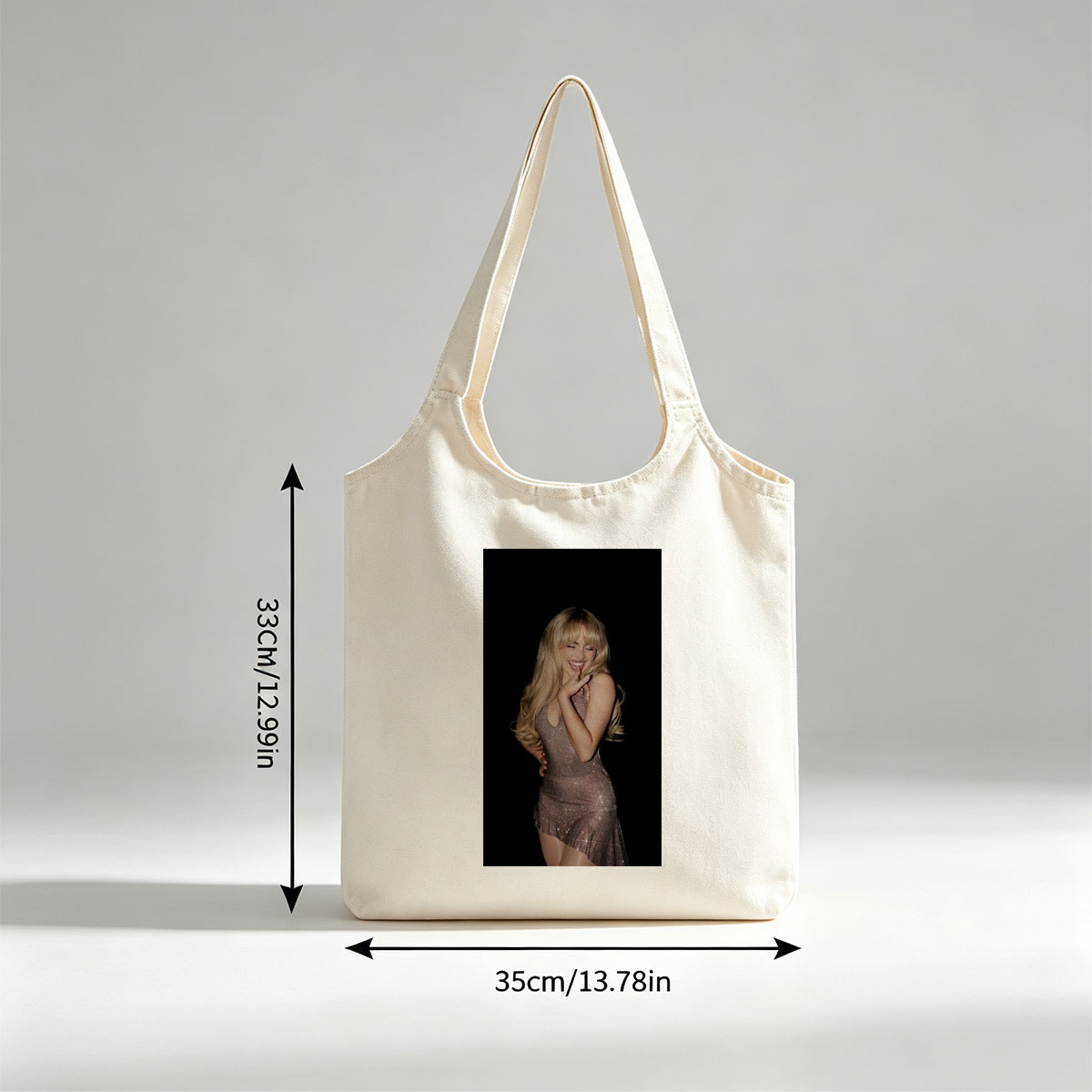 Sabrina Carpenter in a Sparkling Dress Posing with a Smile Against a Black Background - Canvas shoulder bags/