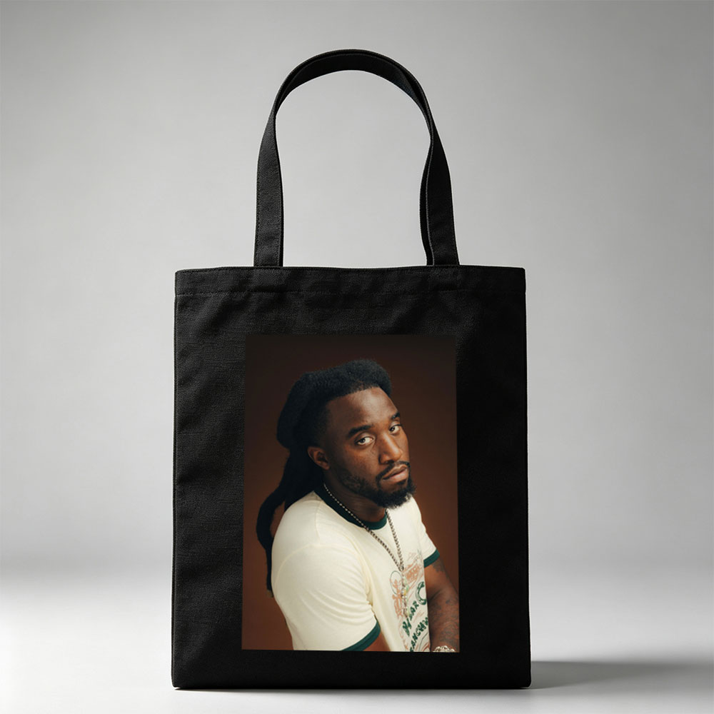 Burna Boy in a Stylish Portrait Wearing a White T-Shirt and Beaded Necklace - Canvas tote bags