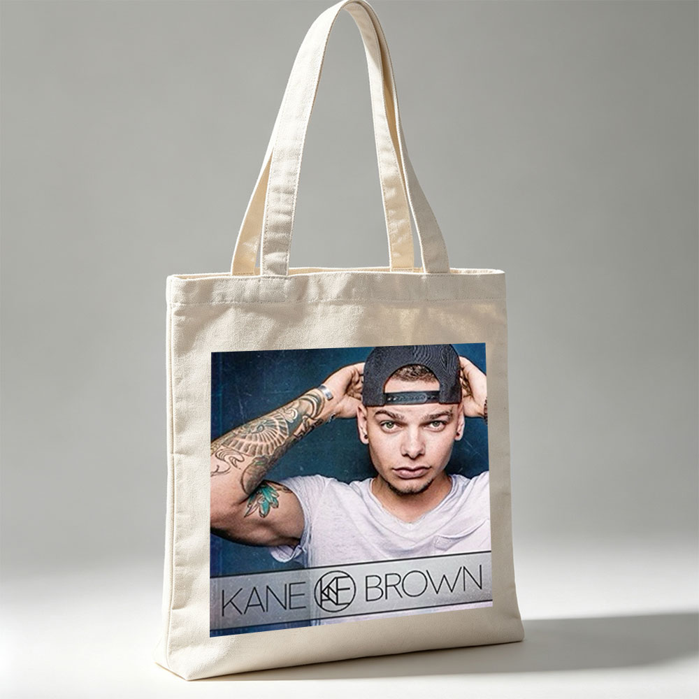 Kane Brown in a Casual Pose with Tattooed Arm and Cap on Dark Background - Canvas tote bags
