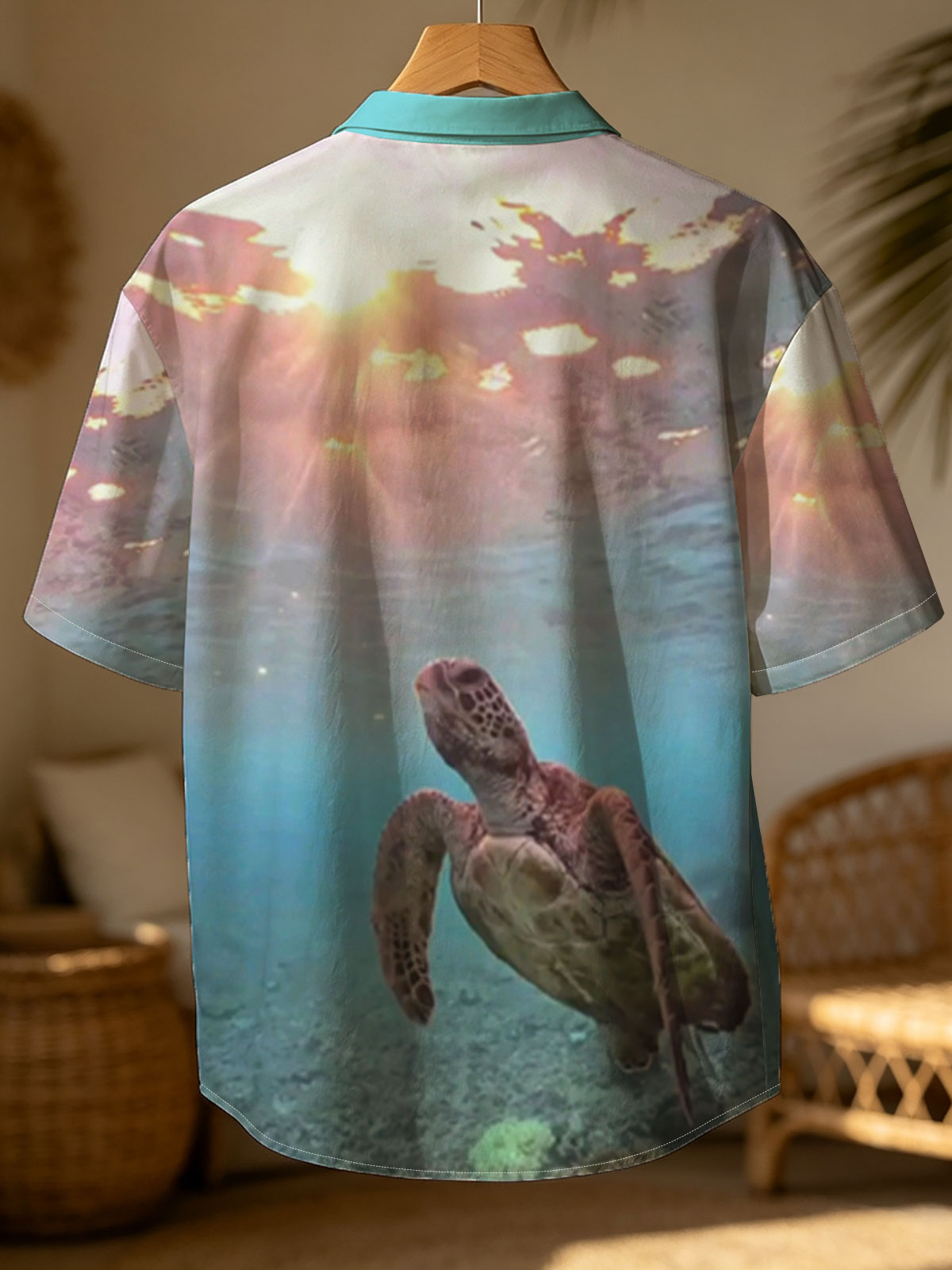 Sea turtle swims gracefully underwater as sunlight filters through the ocean surface. -  Shirt