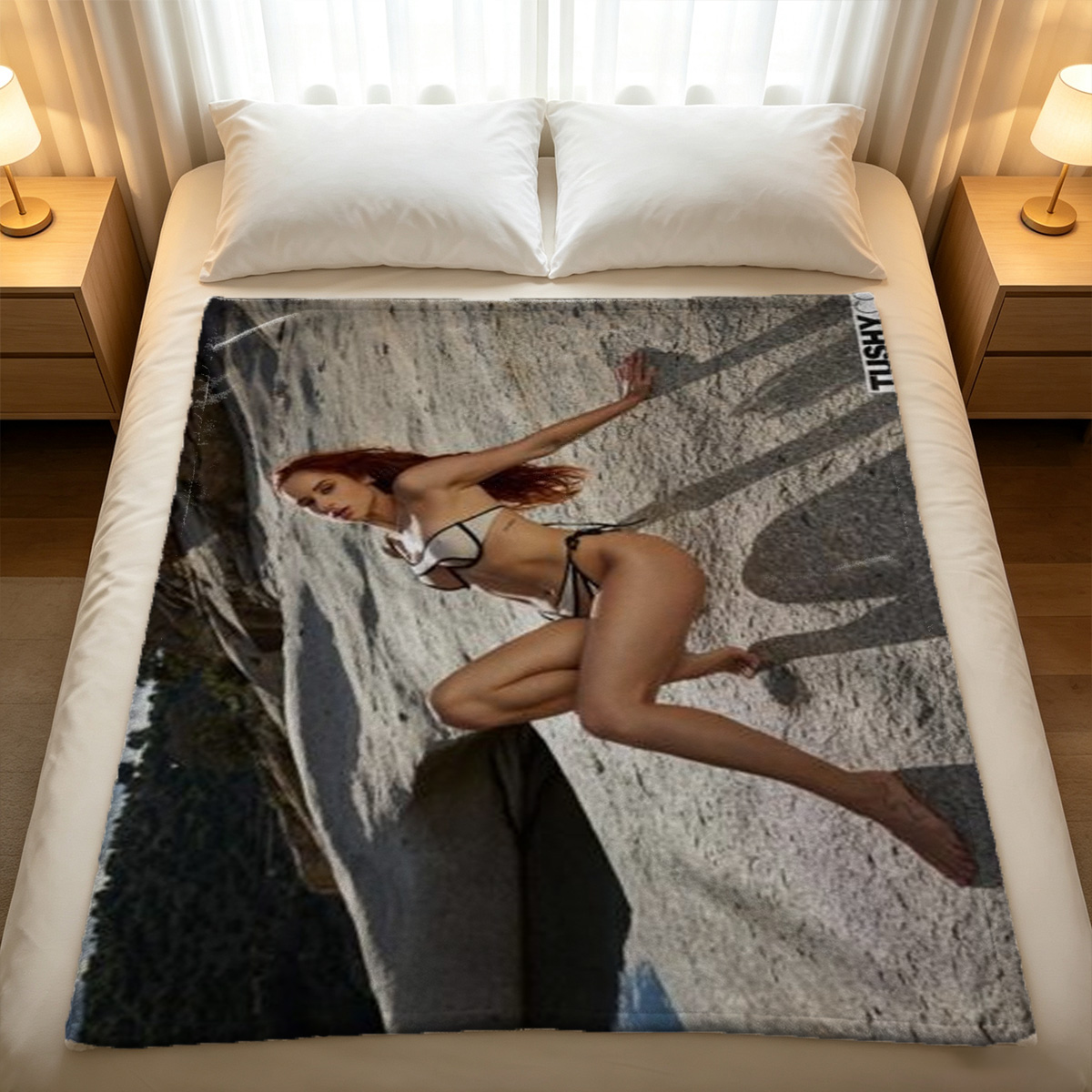 Redhead in white bodysuit lying on dark couch. - Blanket