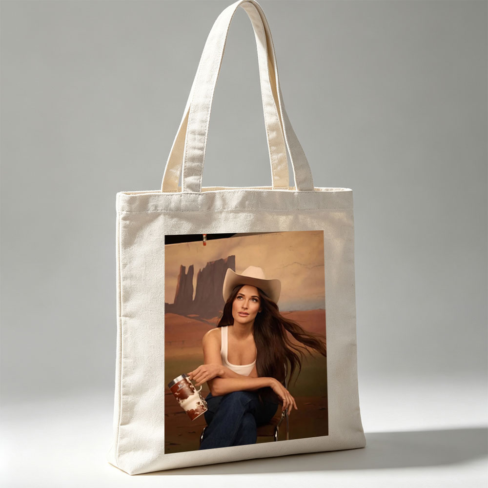 Jennifer Lopez in Cowboy Hat Holding a Mug Against Desert Backdrop - Canvas tote bags