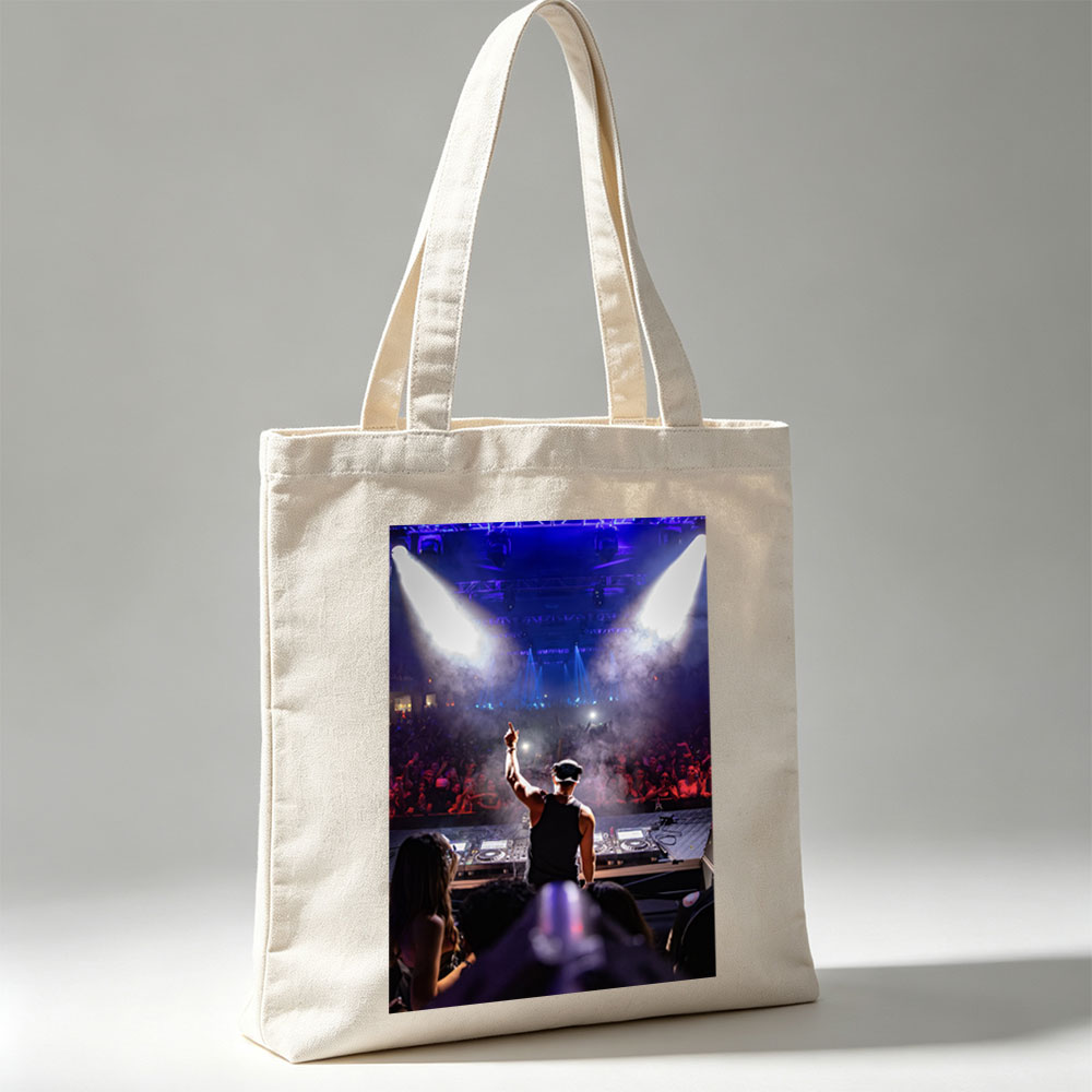 DJ Martin Garrix Performing at a High-Energy Concert with Crowd in the Background - Canvas tote bags