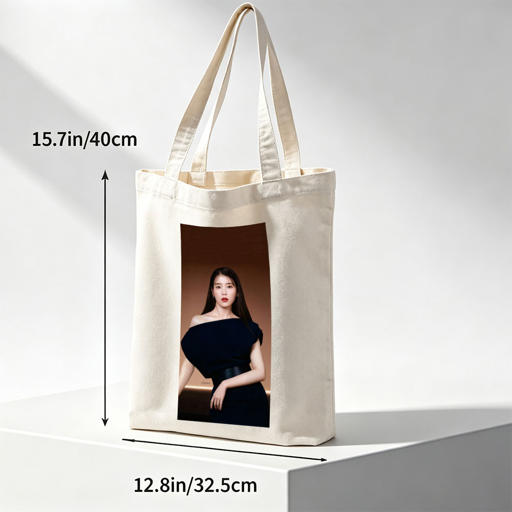 IU in Elegant Black Off-Shoulder Dress Against Warm Brown Background - Canvas tote bags