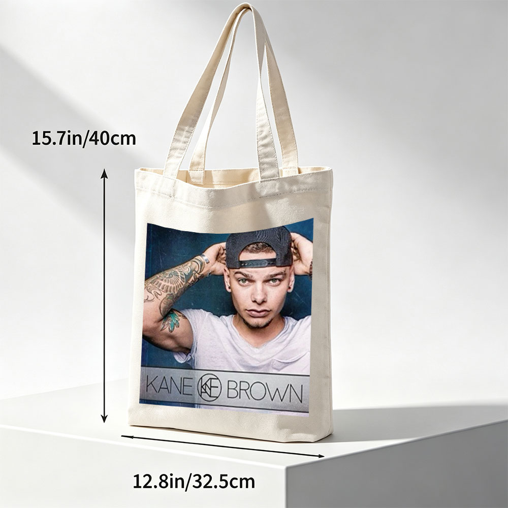 Kane Brown in a Casual Pose with Tattooed Arm and Cap on Dark Background - Canvas tote bags