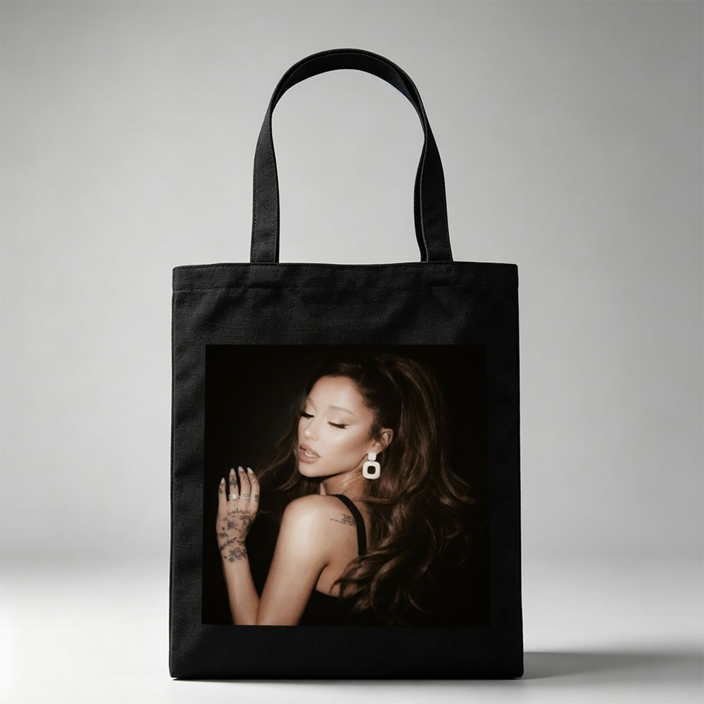Ariana Grande in a Dramatic Pose with Long Hair and Tattoos on Dark Background - Canvas tote bags