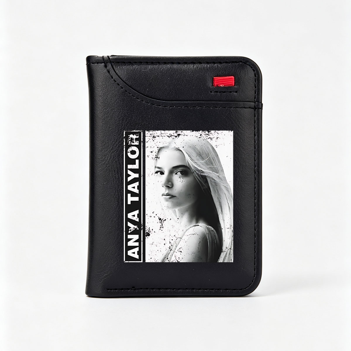 Anya Taylor-Joy in a striking black and white portrait with artistic splatter effects. - Vertical Style Wallet