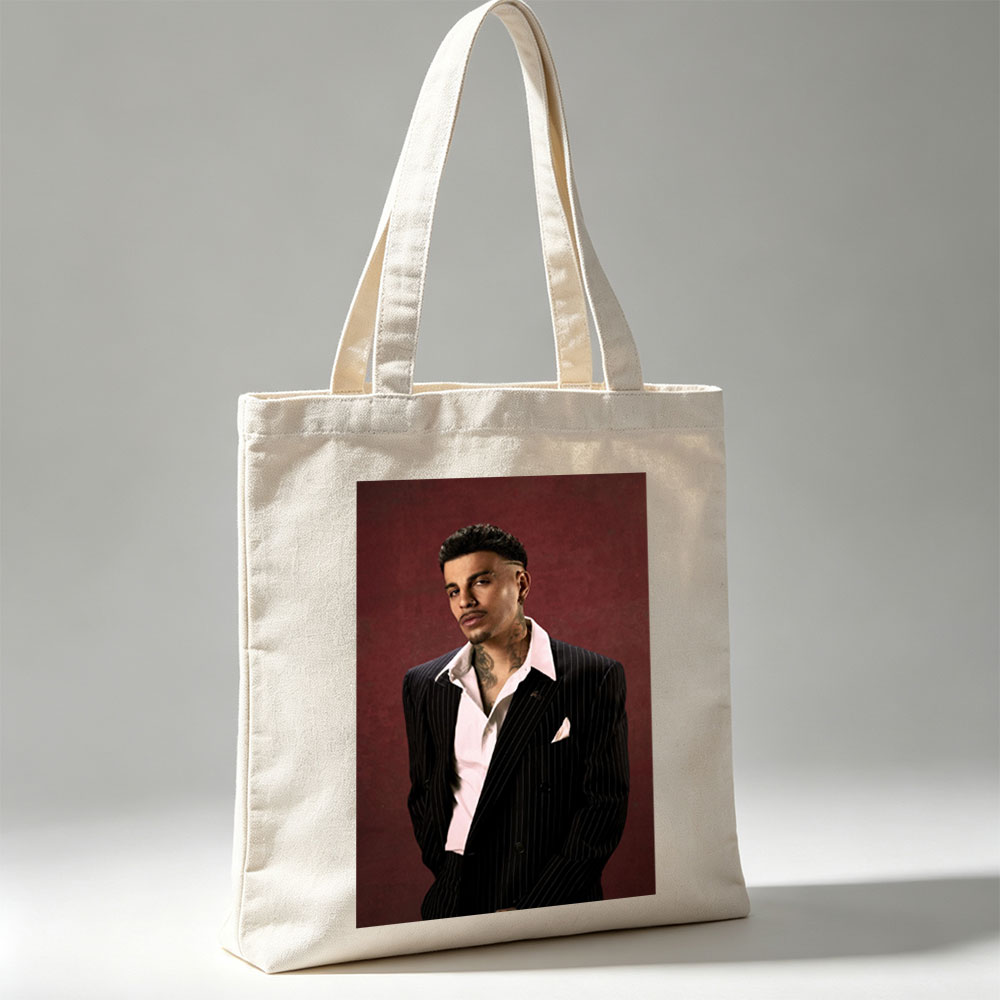 Maluma in a Pinstripe Suit Against a Deep Red Background - Canvas tote bags