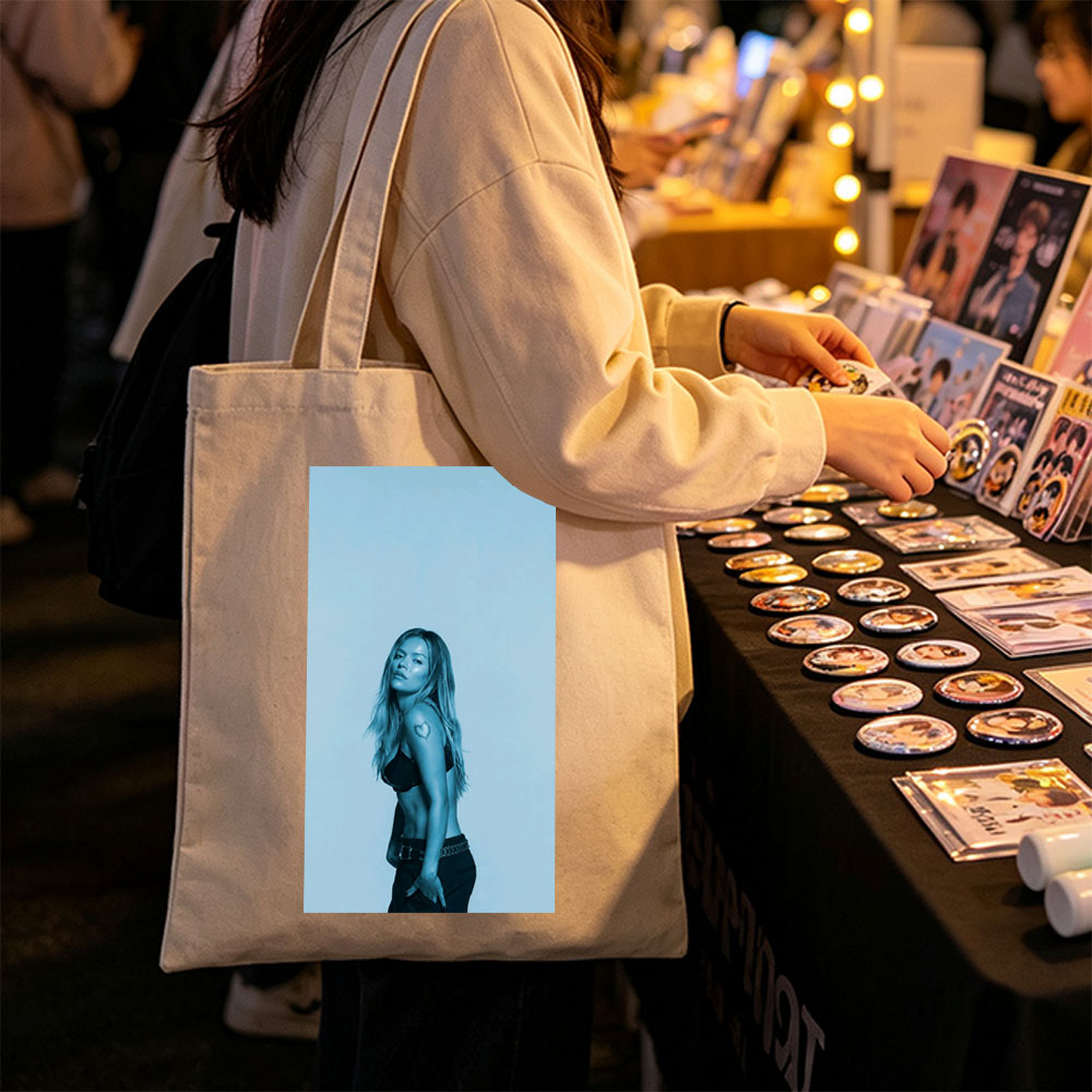 Khloe Kardashian in a Bold Pose with Heart Tattoo and Edgy Fashion Against a Cool Blue Backdrop - Canvas tote bags