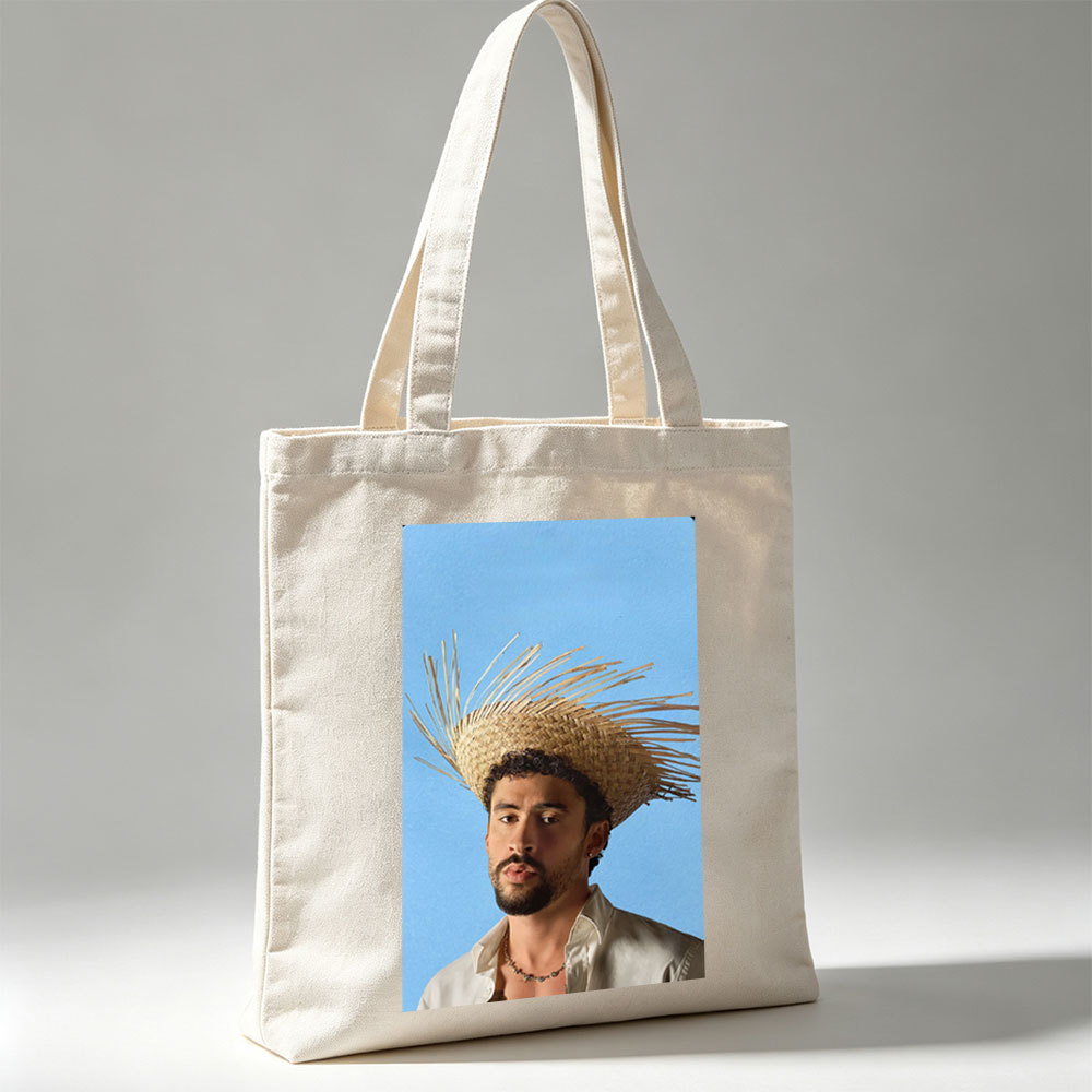 Bad Bunny Wearing a Straw Hat with Spiky Design Against a Blue Background - Canvas tote bags