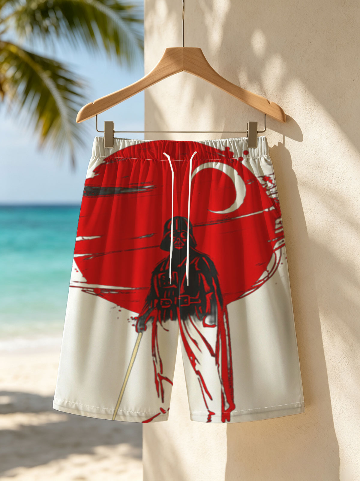 Darth Vader stands before a red sun, wielding a lightsaber in a dramatic silhouette. -  Beach shorts
